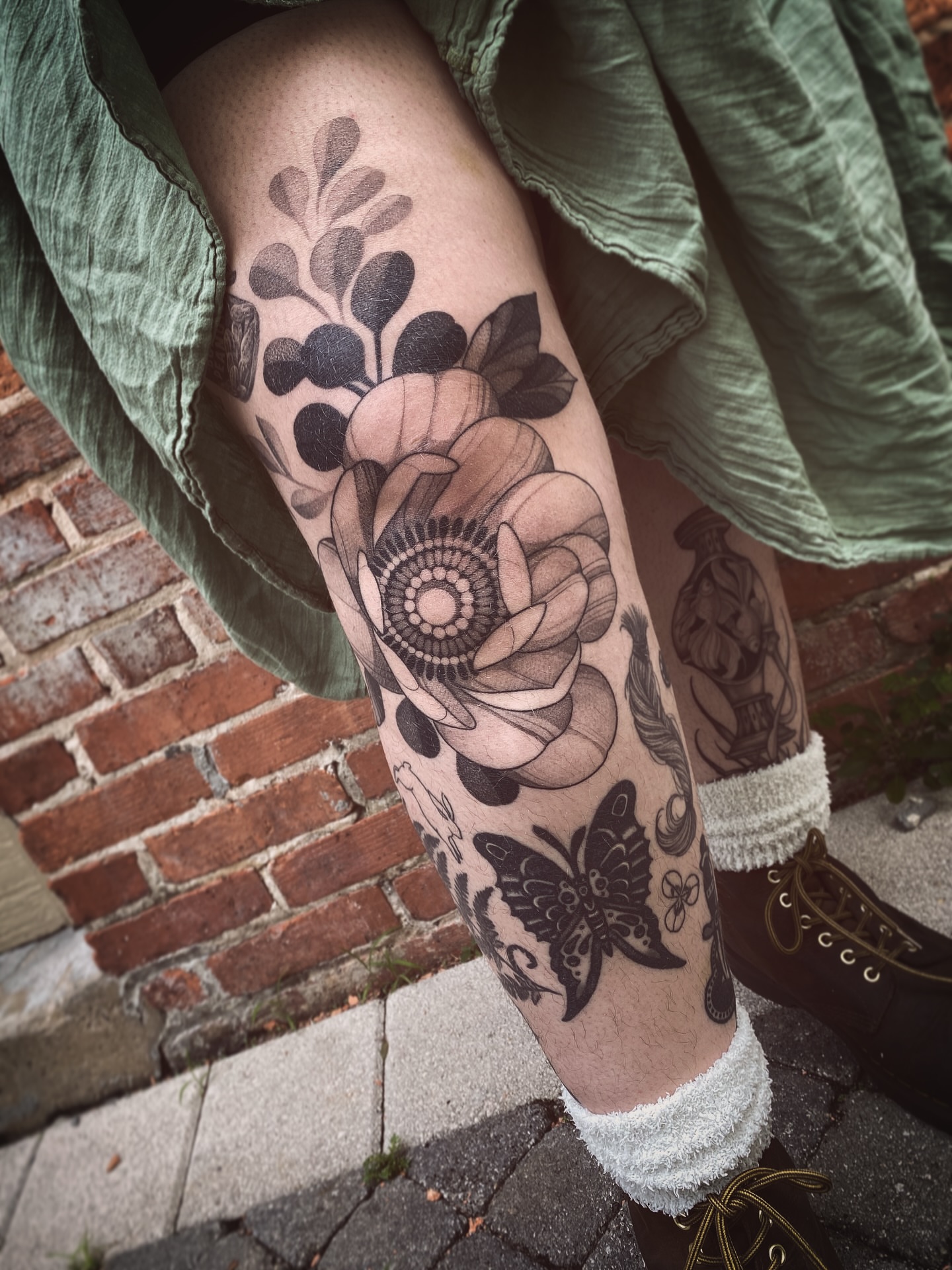 Flower and butterfly black and grey tattoo on the forearm by Natasha Dickinson