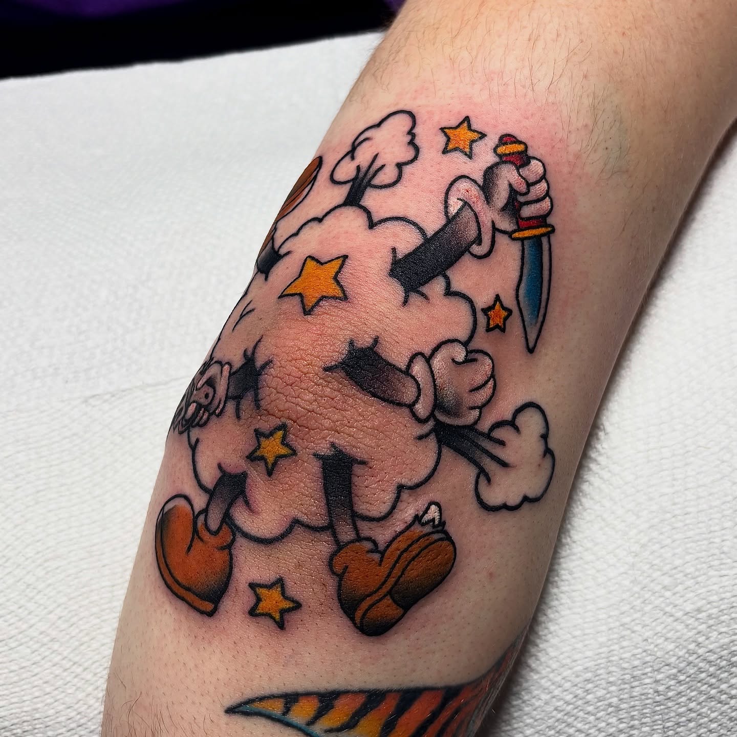 Smoke cloud with dagger and stars American traditional tattoo on the forearm by Dyllan Shipley