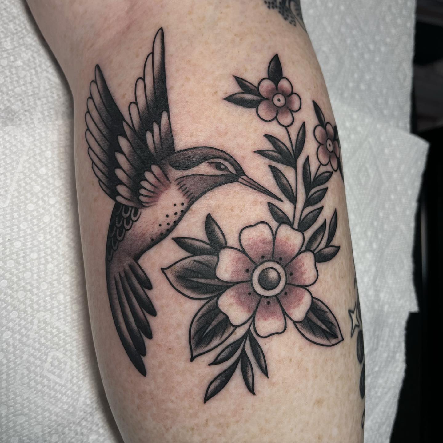 Hummingbird and flowers American traditional tattoo on the forearm by Kayla Faircloth, Charlotte, North Carolina