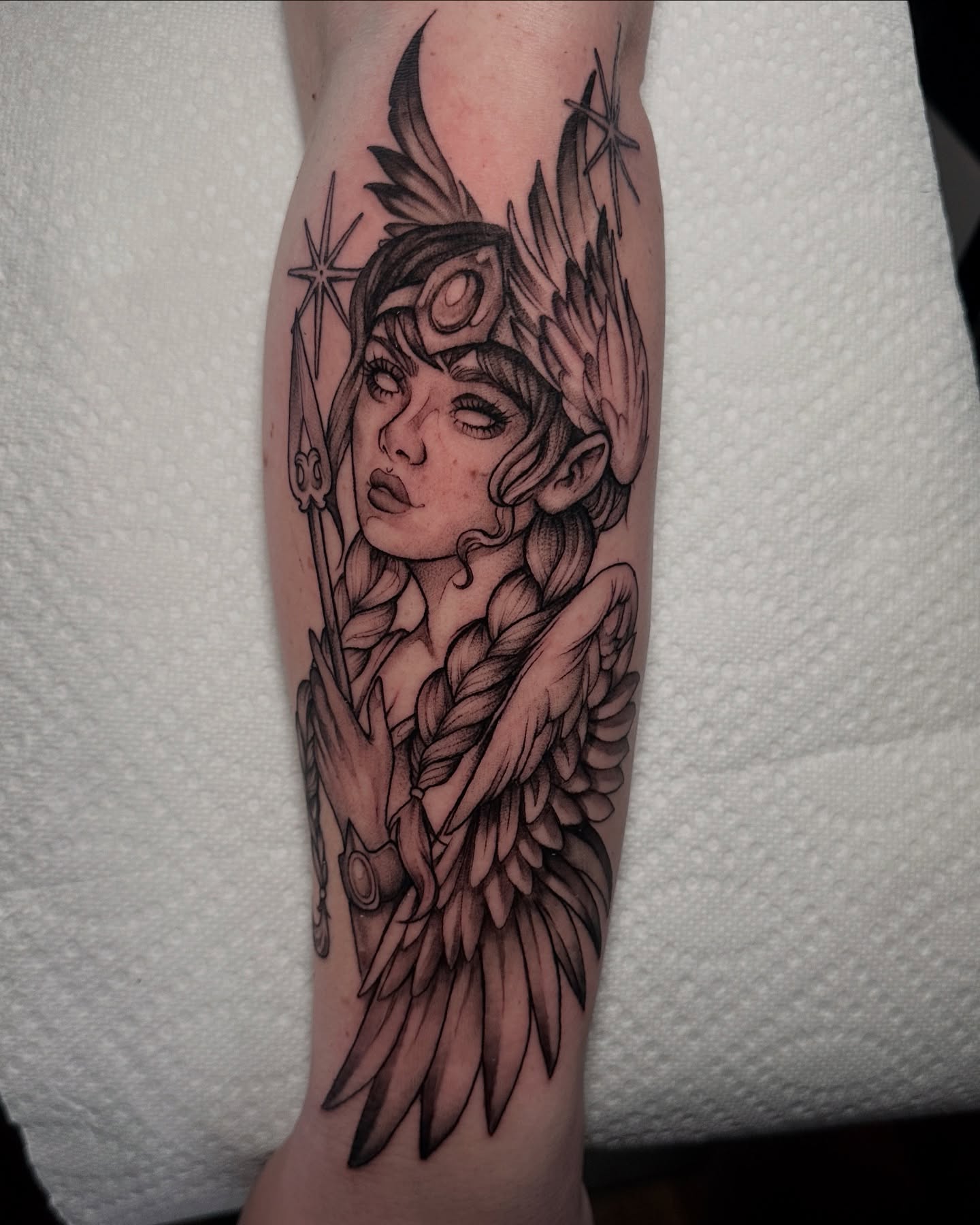 Woman with wings realism tattoo on the forearm by Macayla Myers