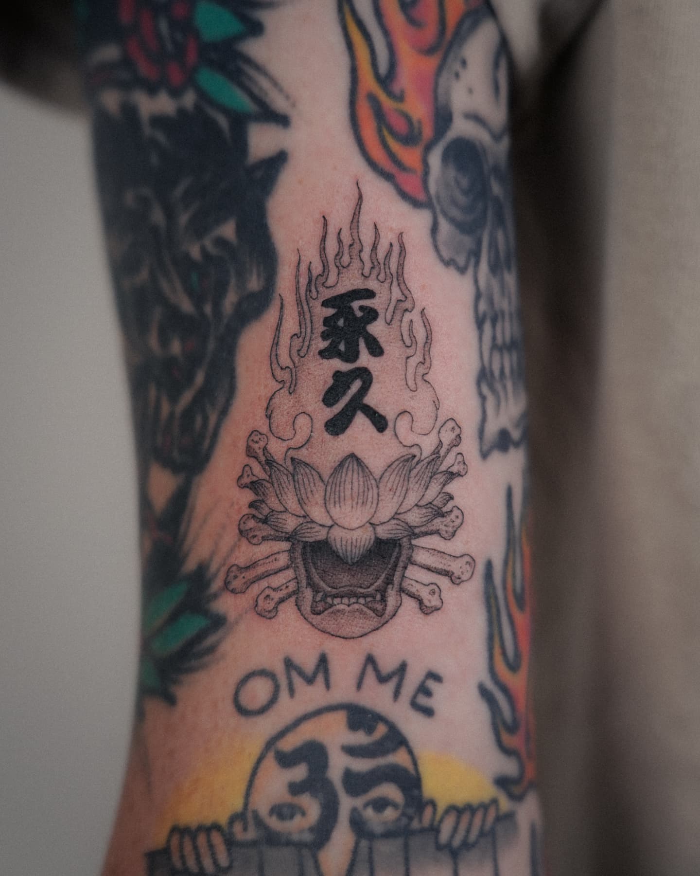 Flaming lotus with kanji American traditional tattoo on the forearm by ๐ฏ๐๐๐๐ ๐ท๐๐๐๐
