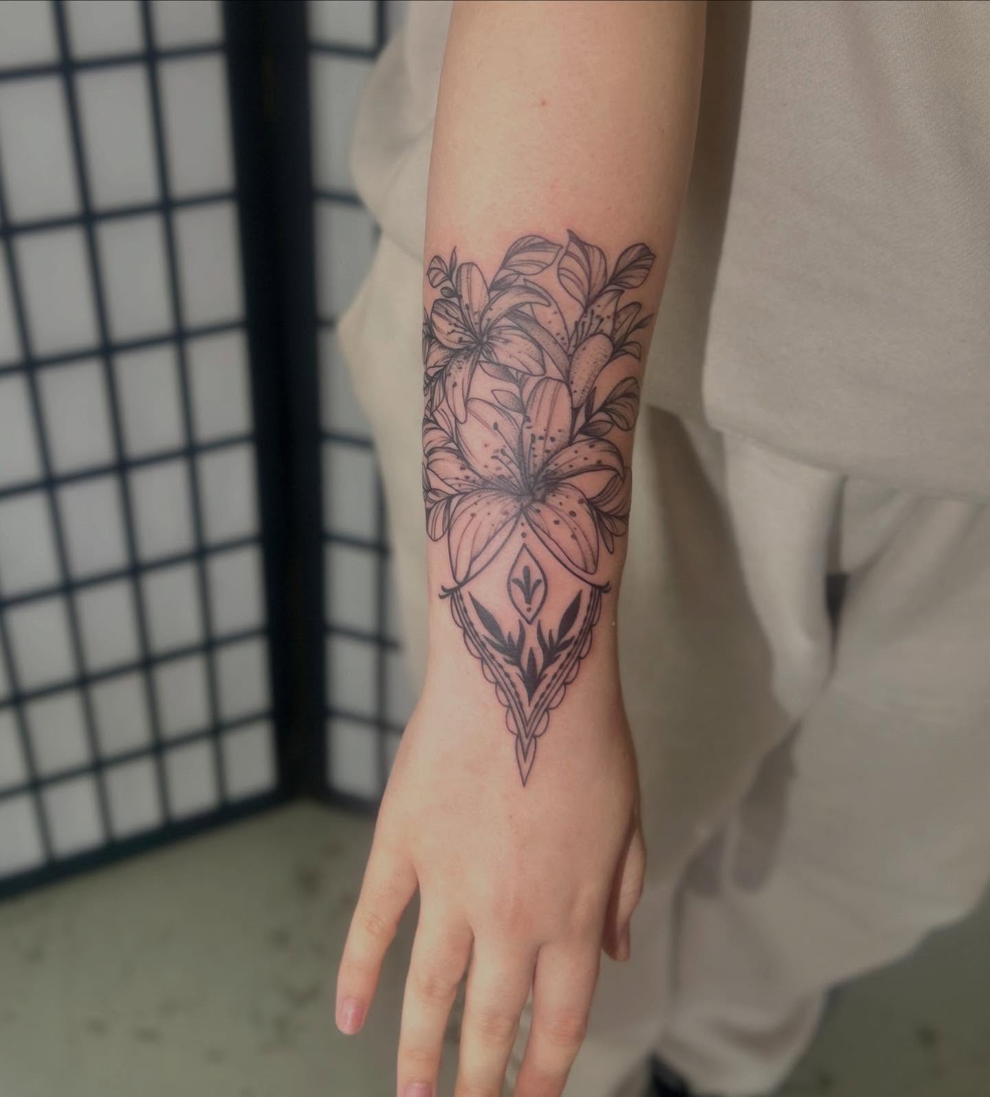 Lily black and grey tattoo on the forearm by ɢɢ sᴛʏʟᴇs