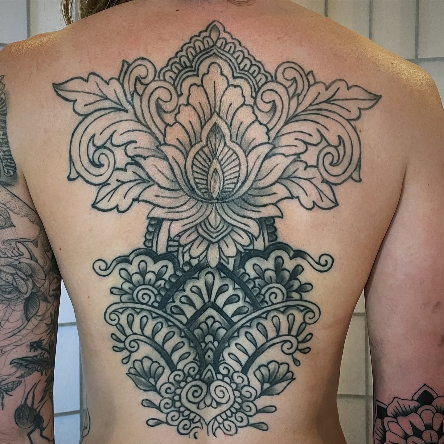 Lotus flower ornamental tattoo on the back by Cam TallBoy SLC Tattoo Artist, Salt Lake City, Utah