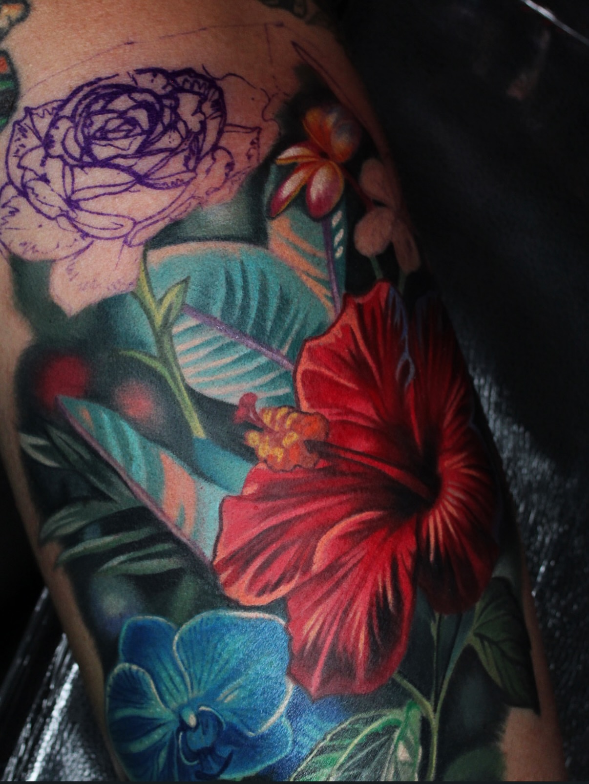 Floral arrangement realism tattoo on the upper arm by Kyle hodge