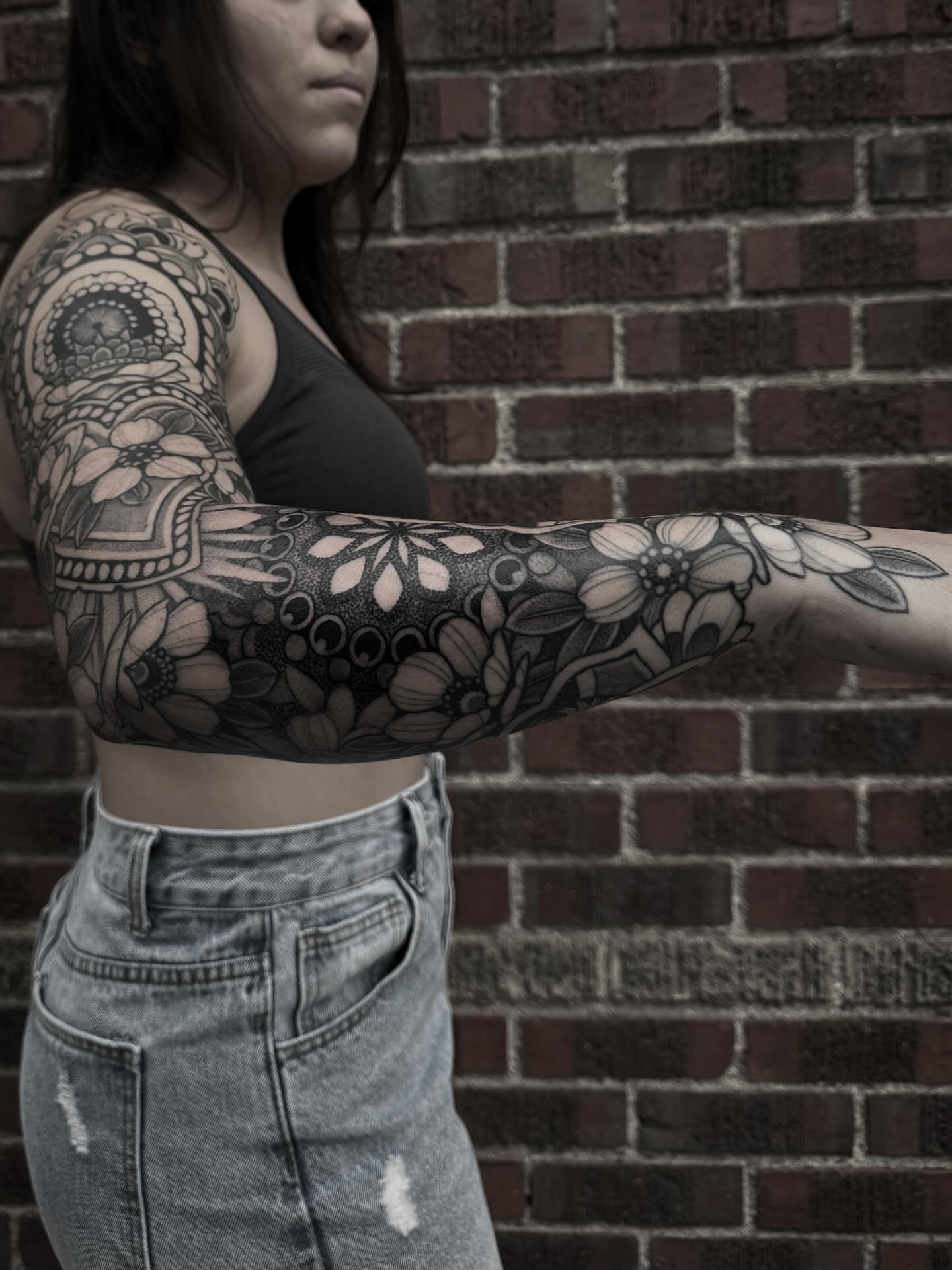 Floral sleeve black and grey tattoo on the upper arm by gina
