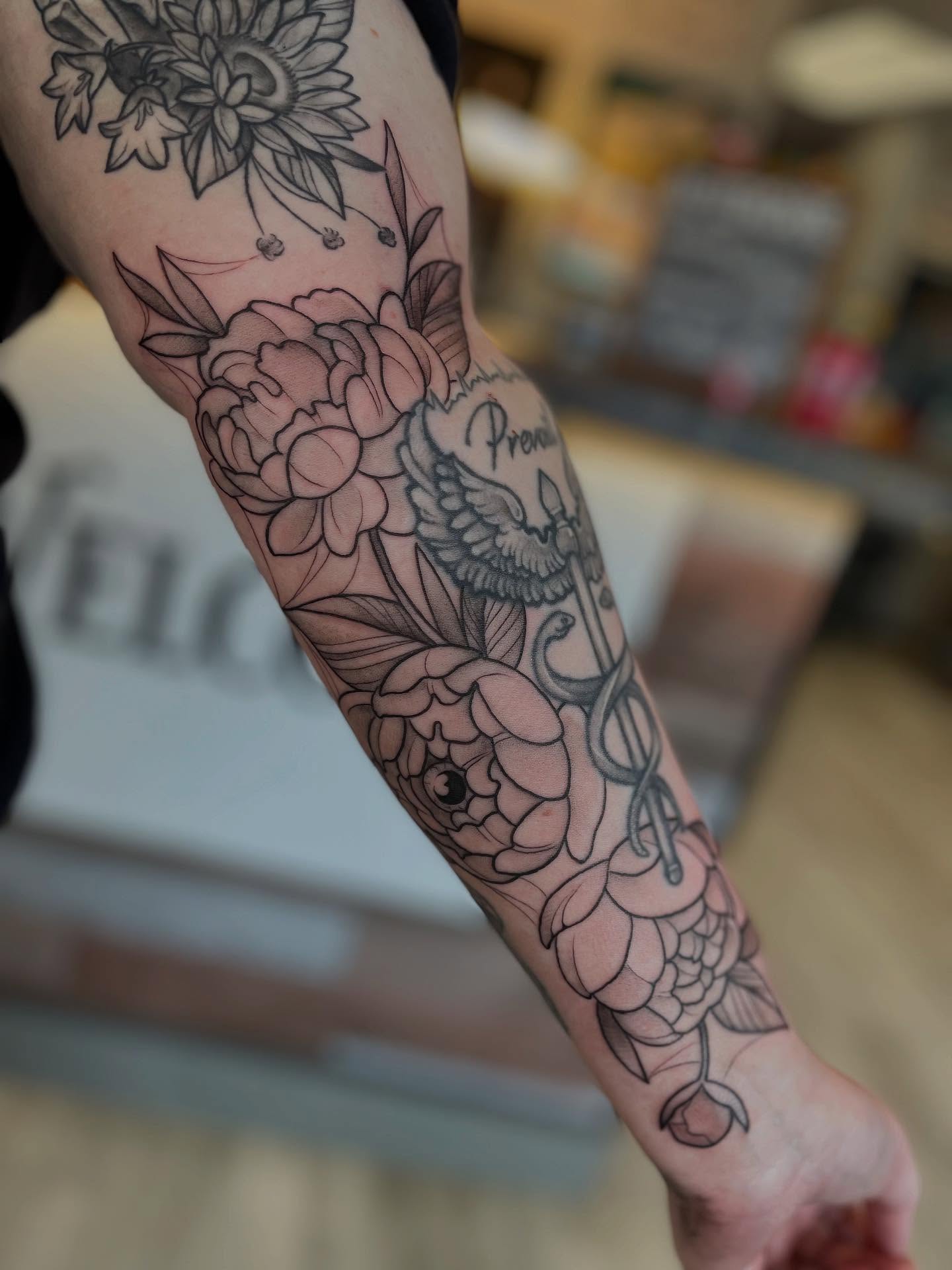Floral arrangement black and grey tattoo on the forearm by Stevie Timmreck, Utica, Michigan