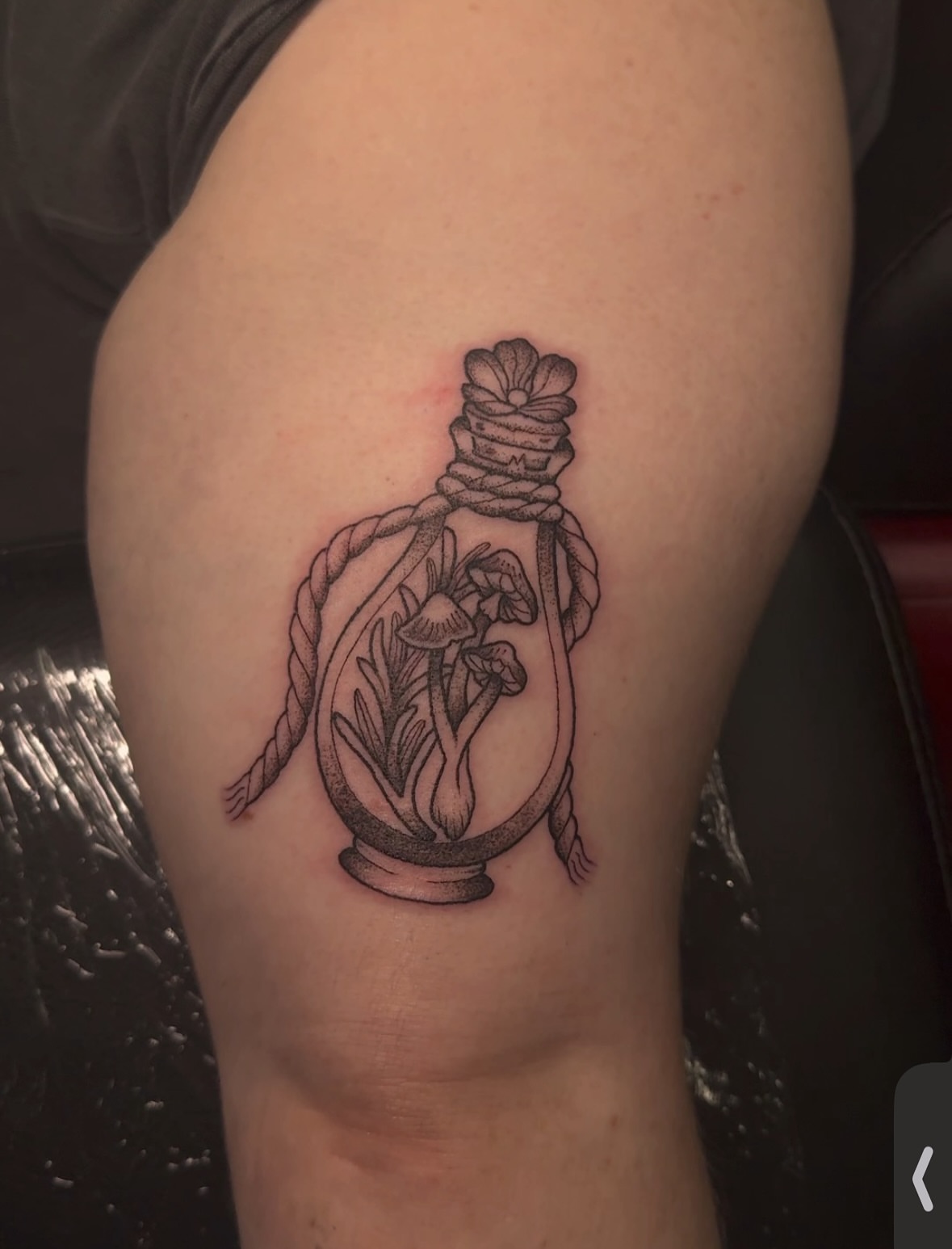 Bottle with mushrooms black and grey tattoo on the thigh by πππͺ‘
