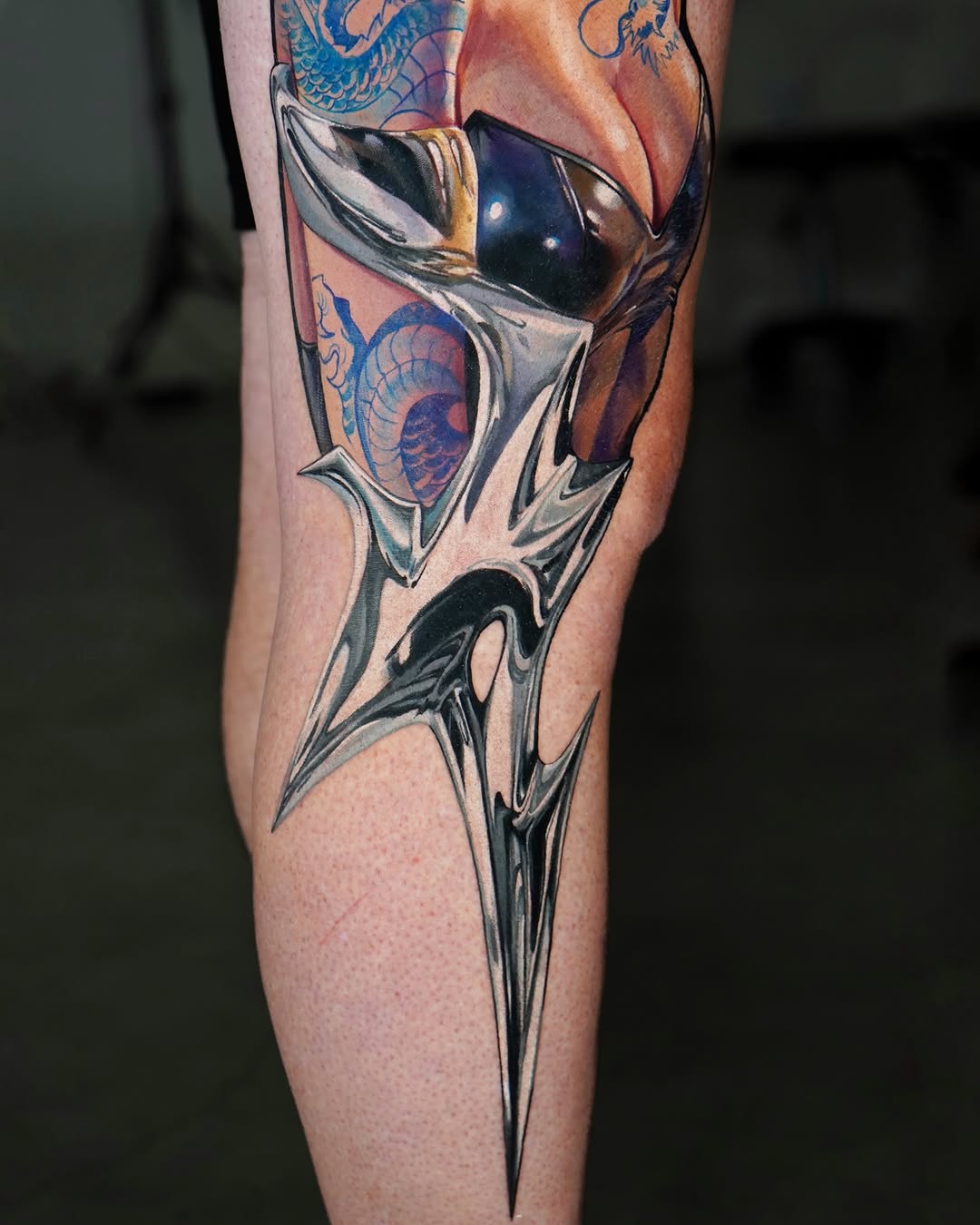 Abstract metallic shard with dragon elements cyber sigilism tattoo on the forearm by Daria Pirojenko