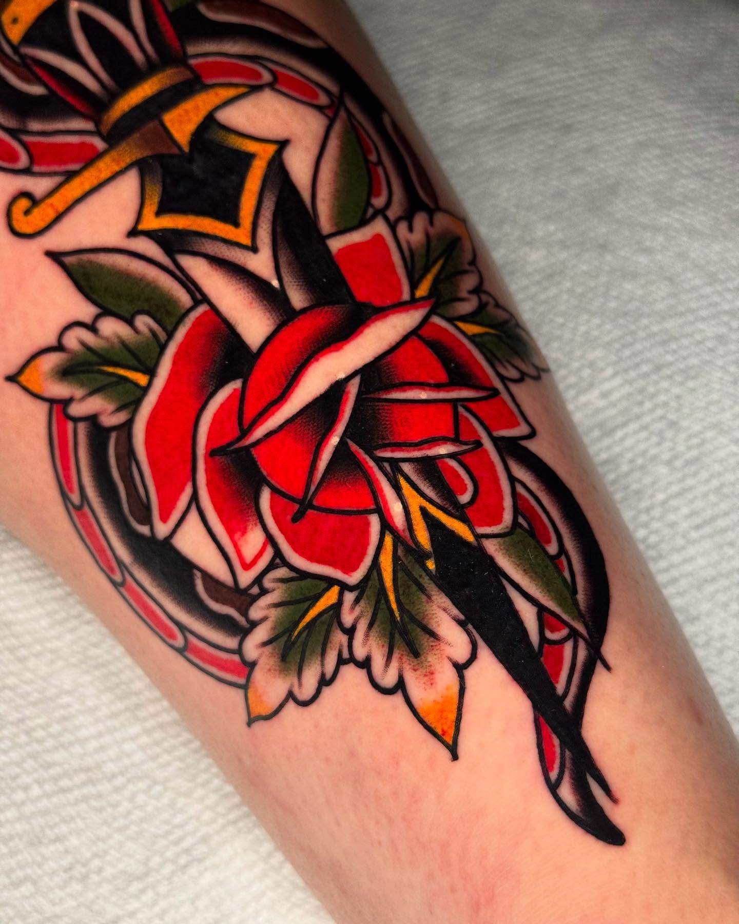 Red rose American traditional tattoo on the forearm by Robert Graye