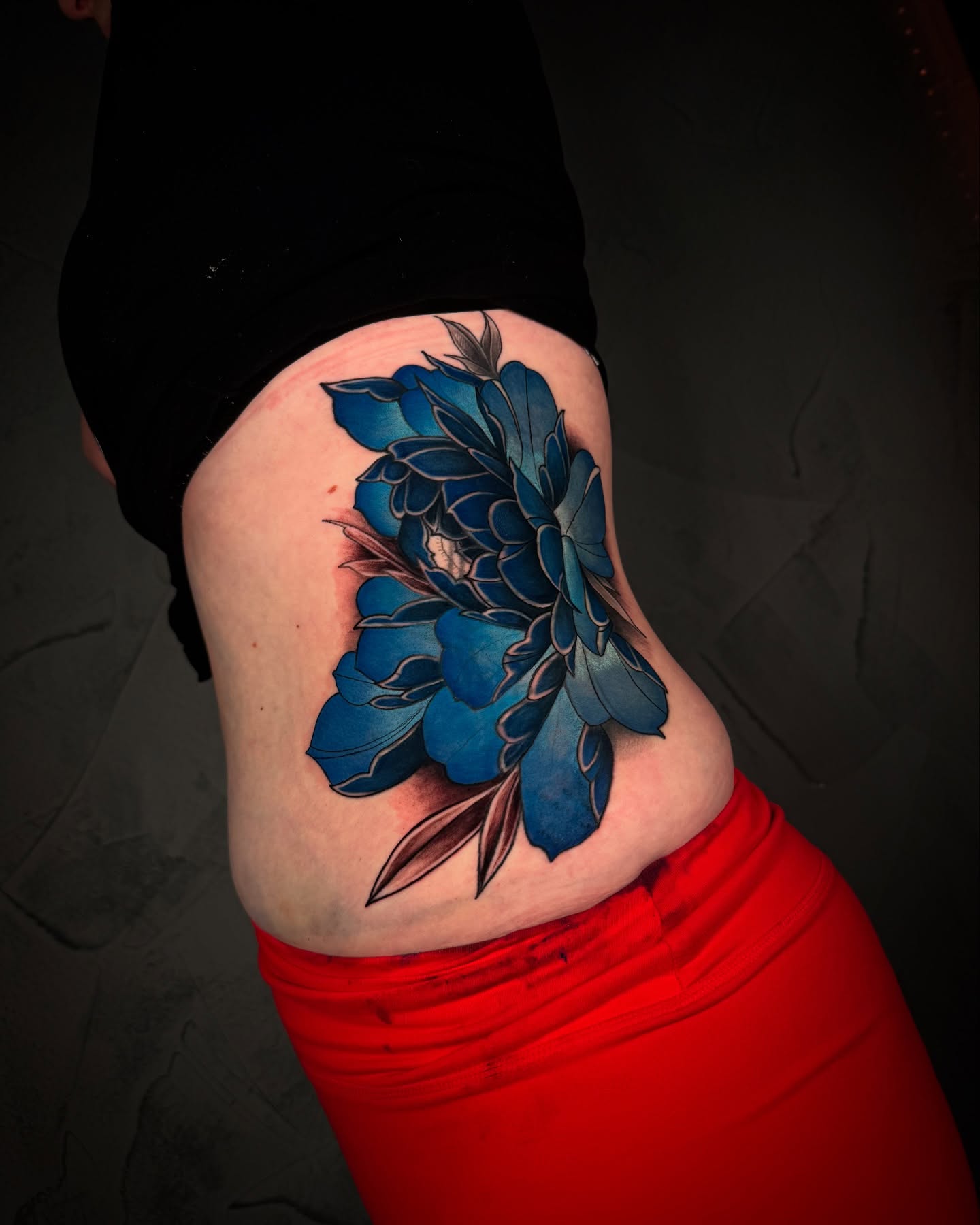 Blue flower new school tattoo on the thigh by Ethan Lund