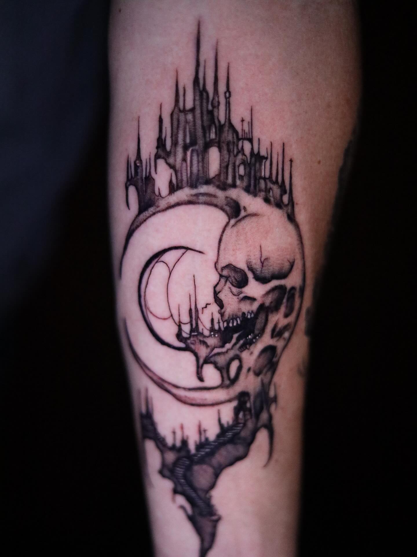 Skull and castle dark realism tattoo on the forearm by Haley Byers