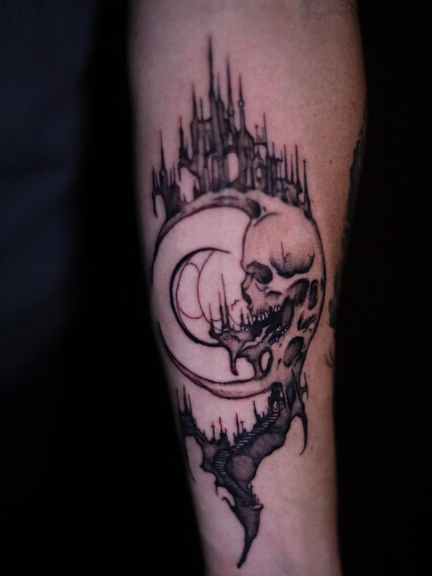 Skull and castle dark realism tattoo on the forearm by Haley Byers