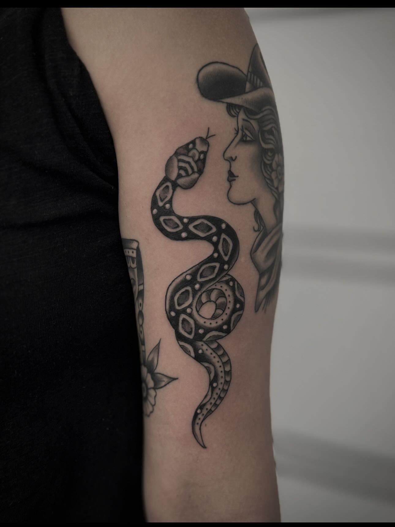 Snake and woman realism tattoo on the forearm by Micah Norman, San Francisco, California