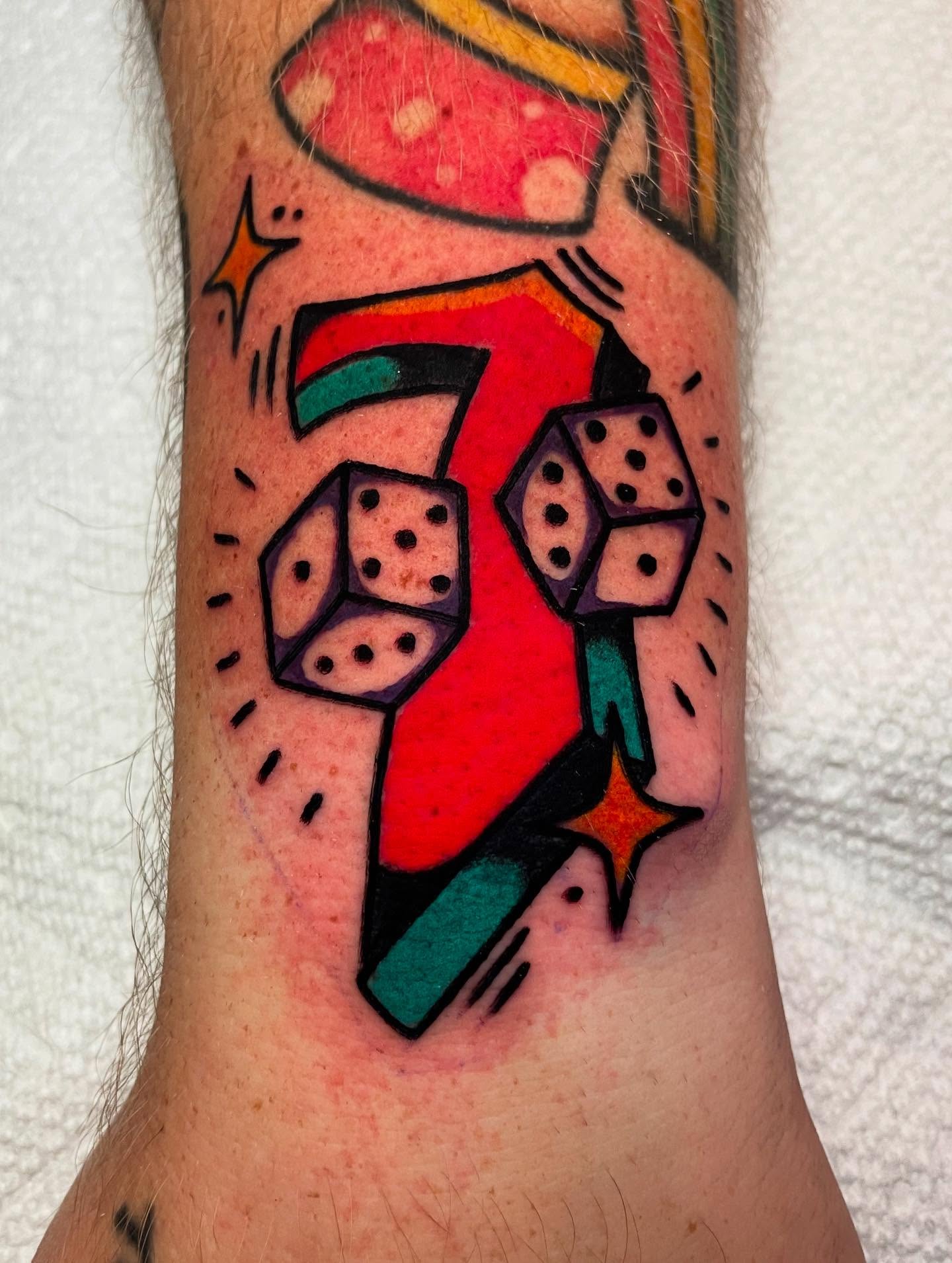 Dice and number seven geometric tattoo on the forearm by Jacob, Marion, Illinois