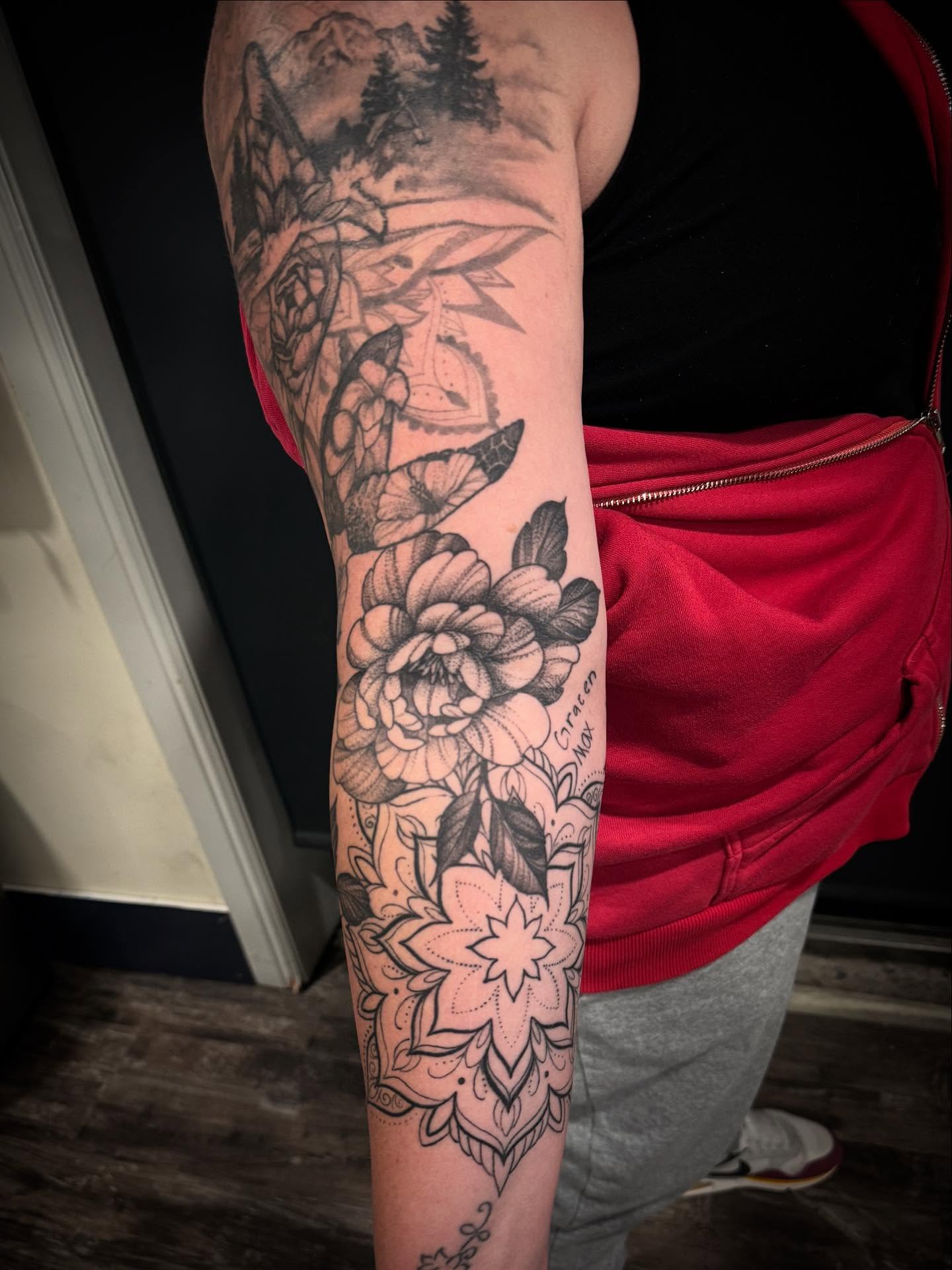 Floral landscape realism tattoo on the forearm by Brennan Walker, Orem, Utah