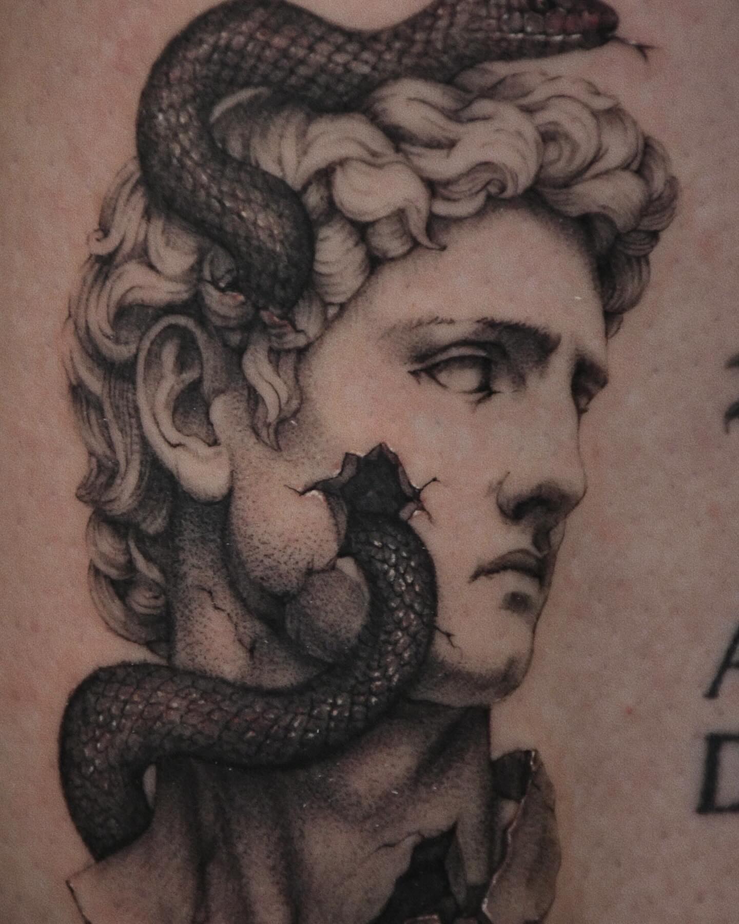 Snake and bust realism tattoo on the forearm by Gary Zhong, Upland, California