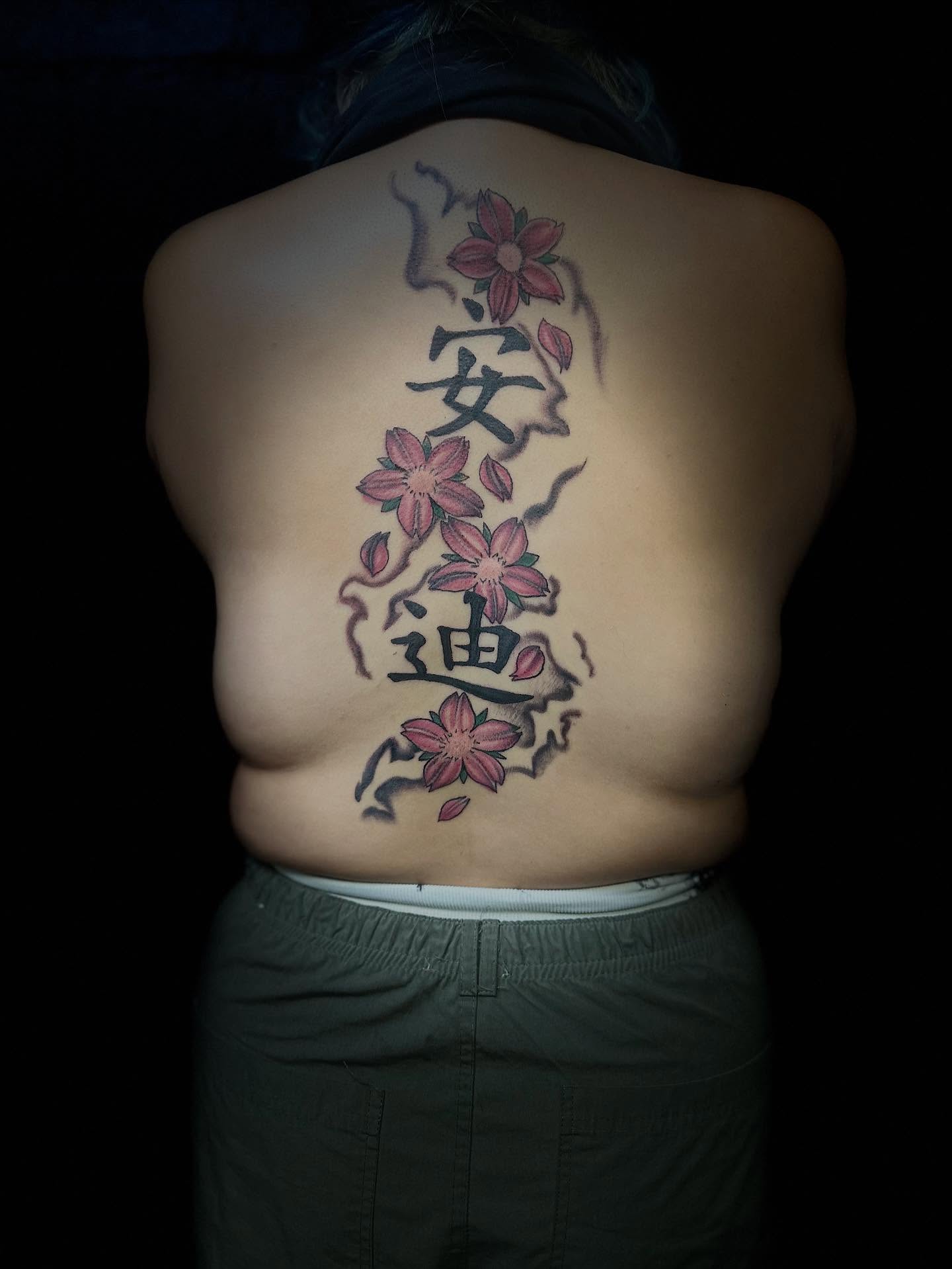 Cherry blossoms and kanji japanese irezumi tattoo on the back by Aj Negrete Jr.