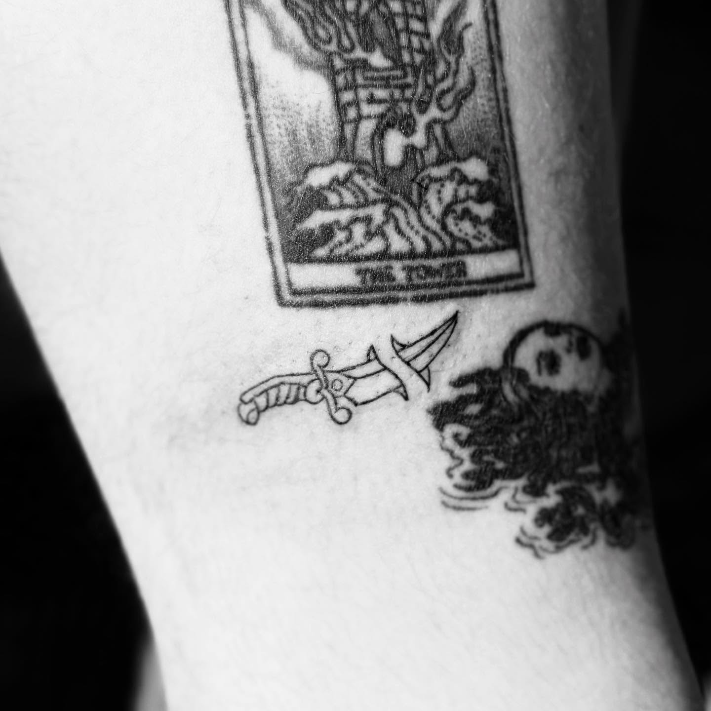 Tarot card black and grey tattoo on the forearm by Kylee Snow