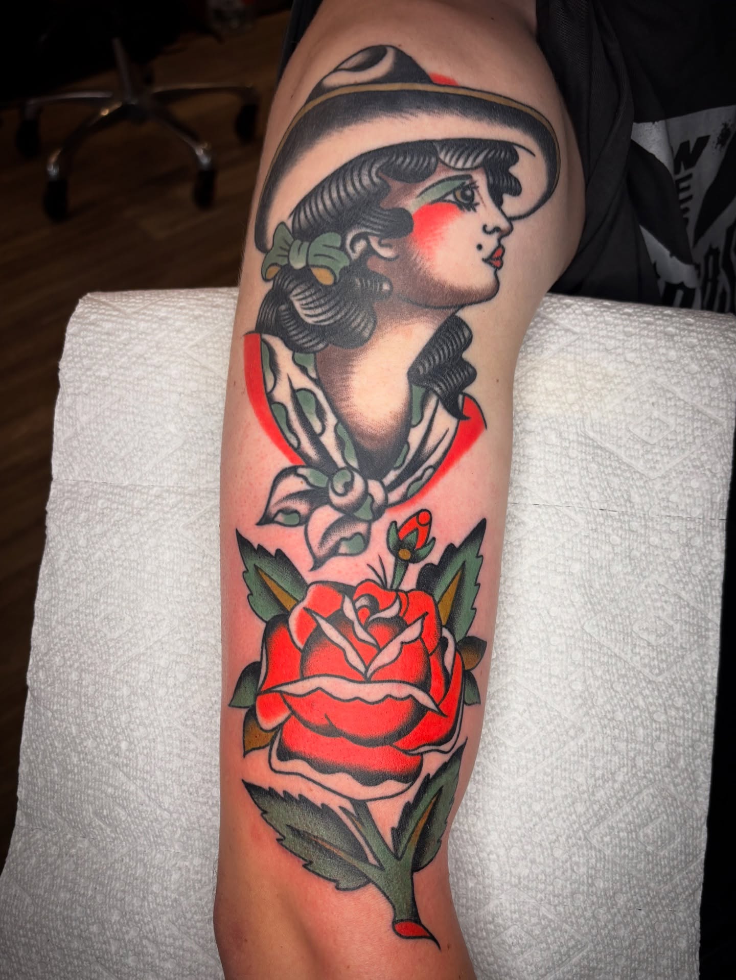 Woman with hat and rose American traditional tattoo on the forearm by Charlie Dunkel Tattoo