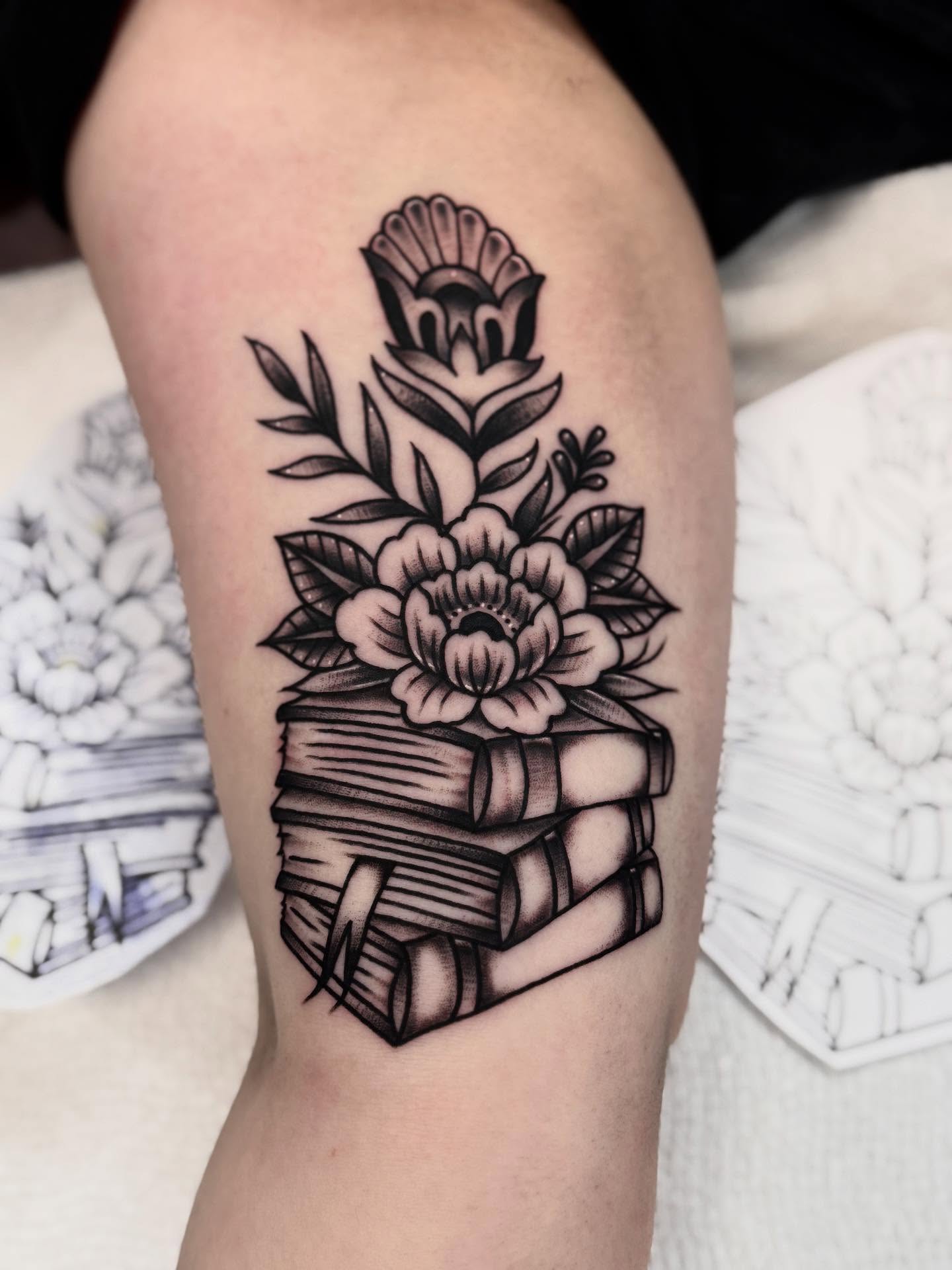 Stack of books with flowers American traditional tattoo on the forearm by ๐ท๐๐๐๐ ๐ฎ๐๐๐๐