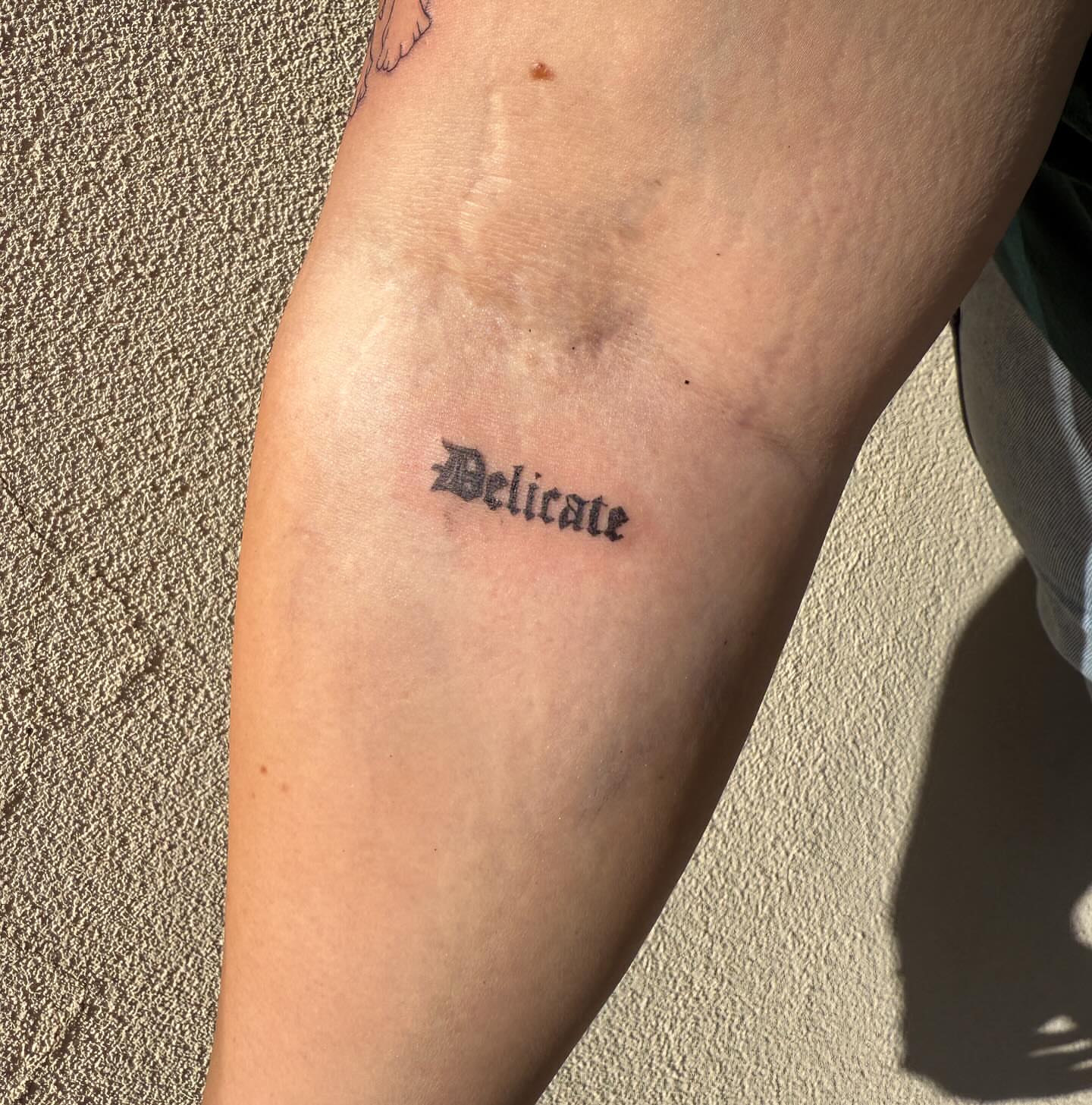 Delicate lettering script tattoo on the forearm by Kylee Snow