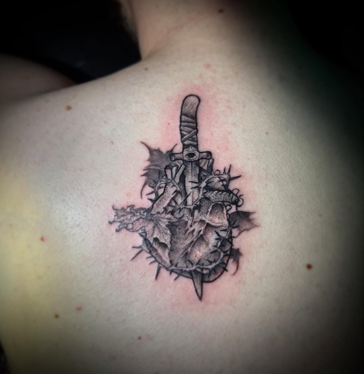 Heart with dagger realism tattoo on the shoulder by AaronAdlerTattoos.com, Cincinnati