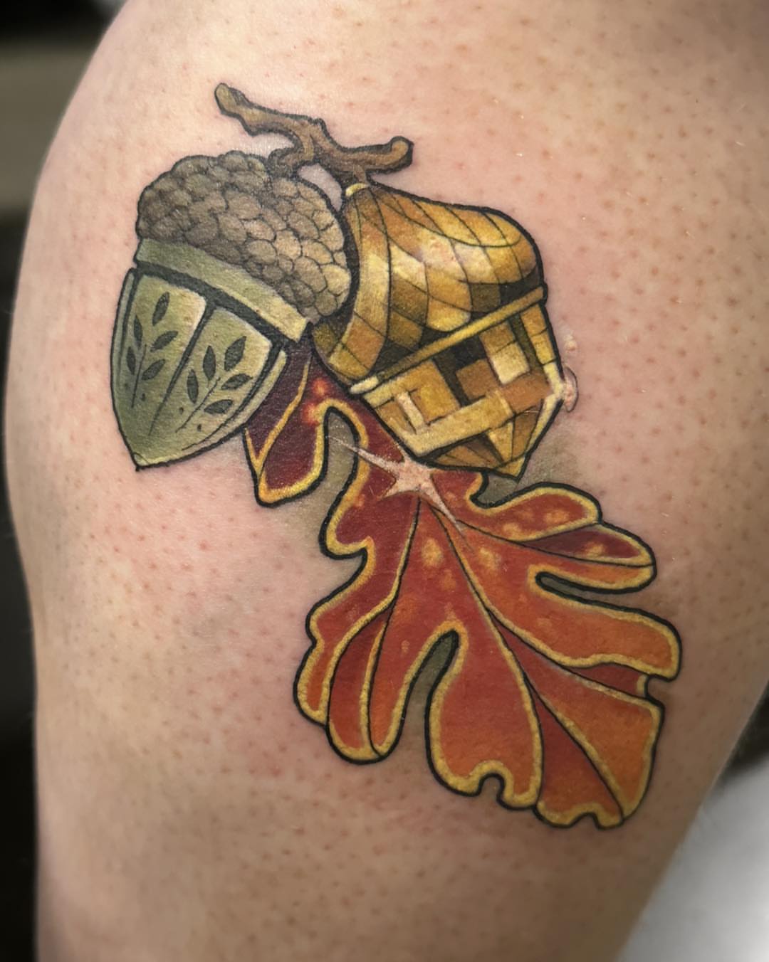 Acorn and leaf realism tattoo on the shoulder by Harper Clark