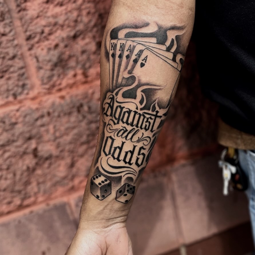 Royal flush and dice black and grey tattoo on the forearm by Aaron Carey, Salem, Oregon