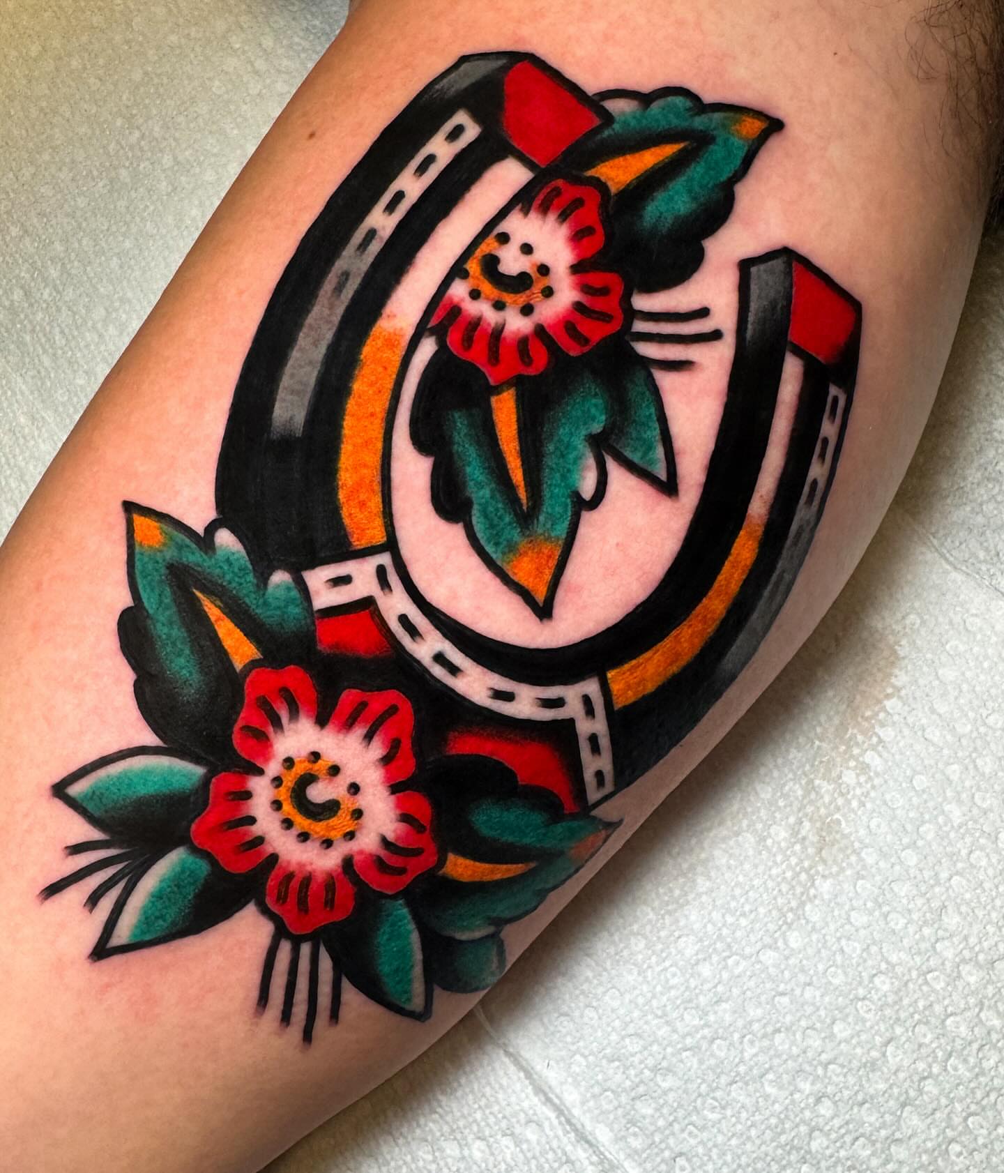Horseshoe and flowers American traditional tattoo on the forearm by Alex Kass 🥩 San Antonio TX, San Antonio, Texas