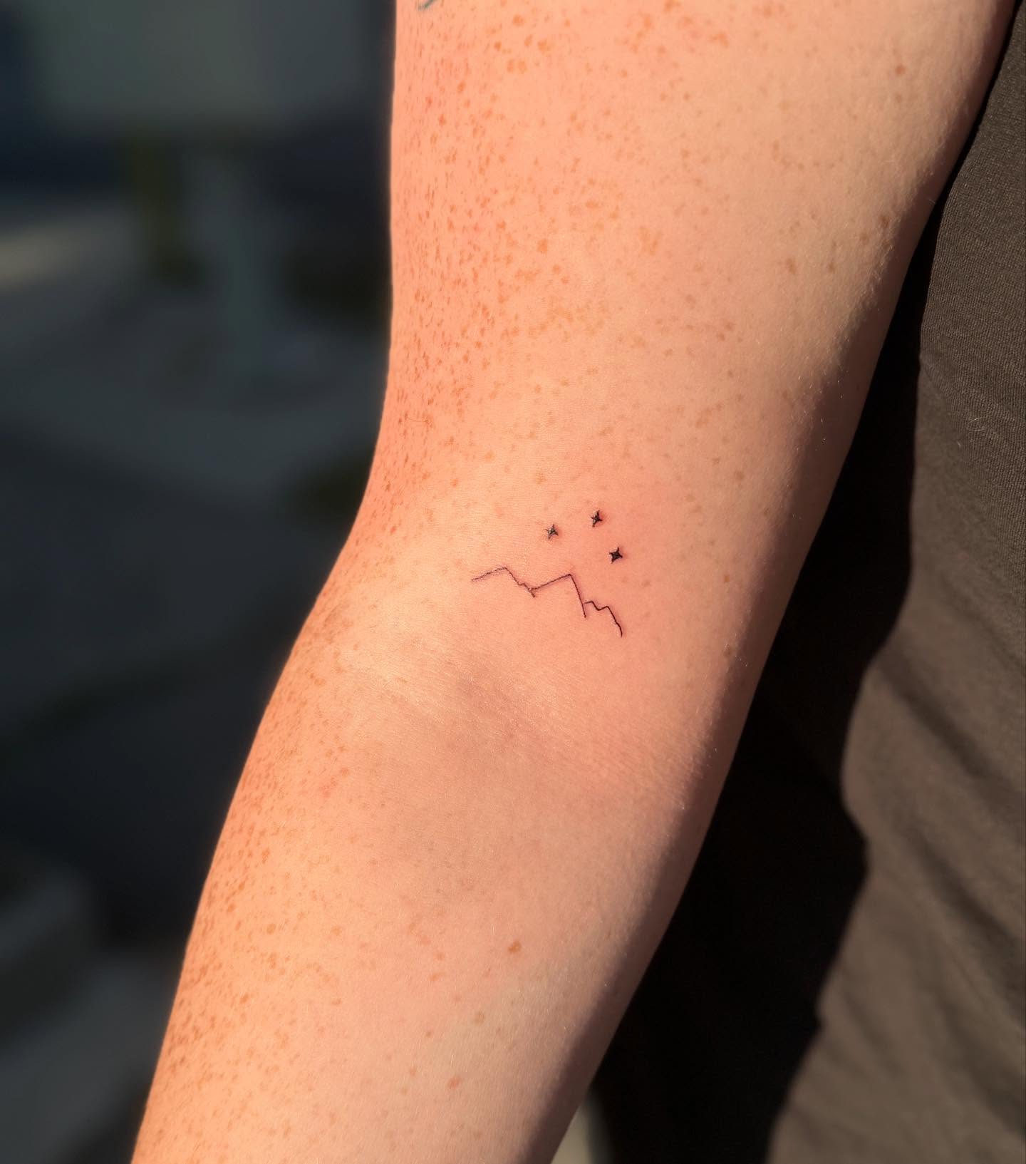 Constellation minimalist tattoo on the forearm by Kylee Snow