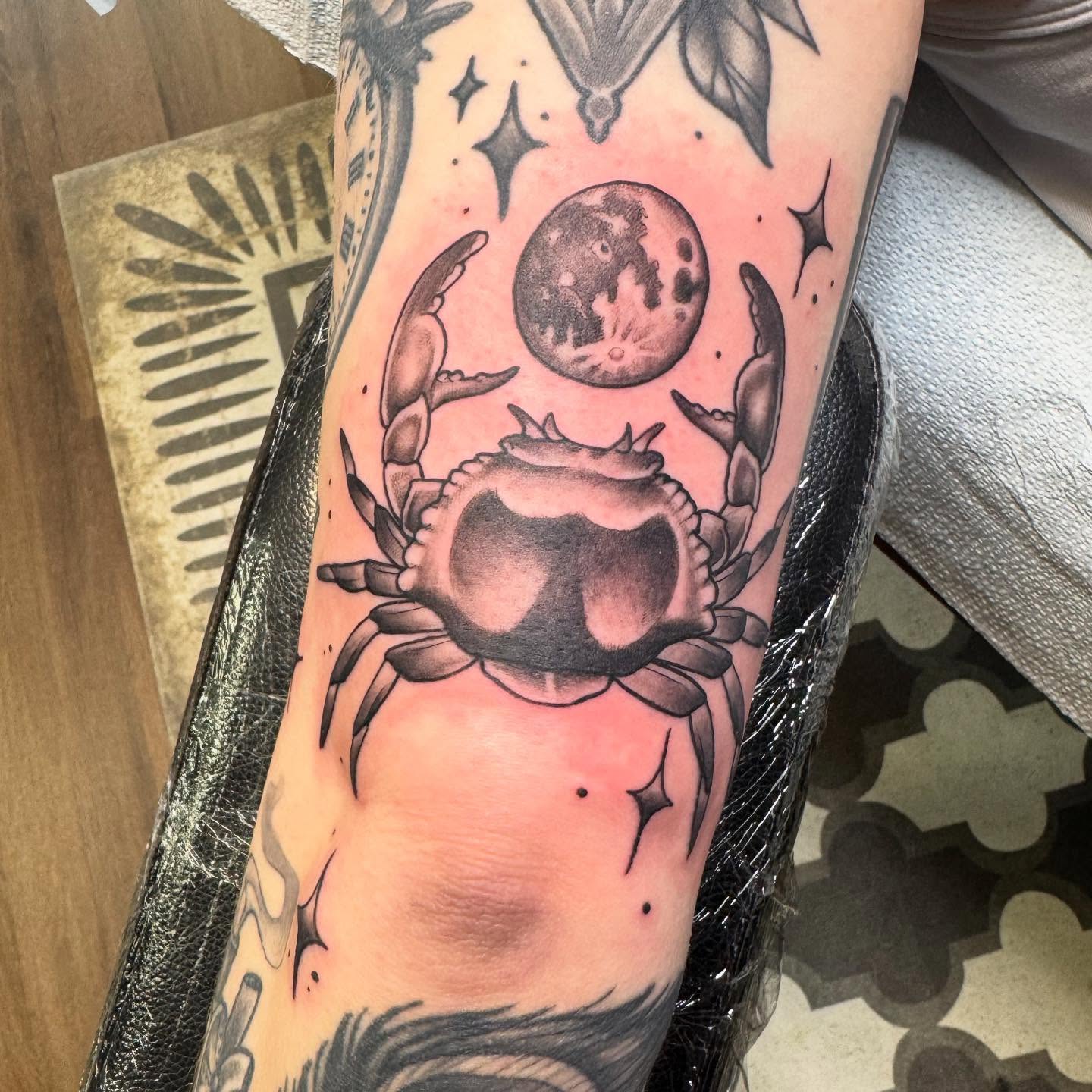 Crab and moon black and grey tattoo on the forearm by Nikki Powills