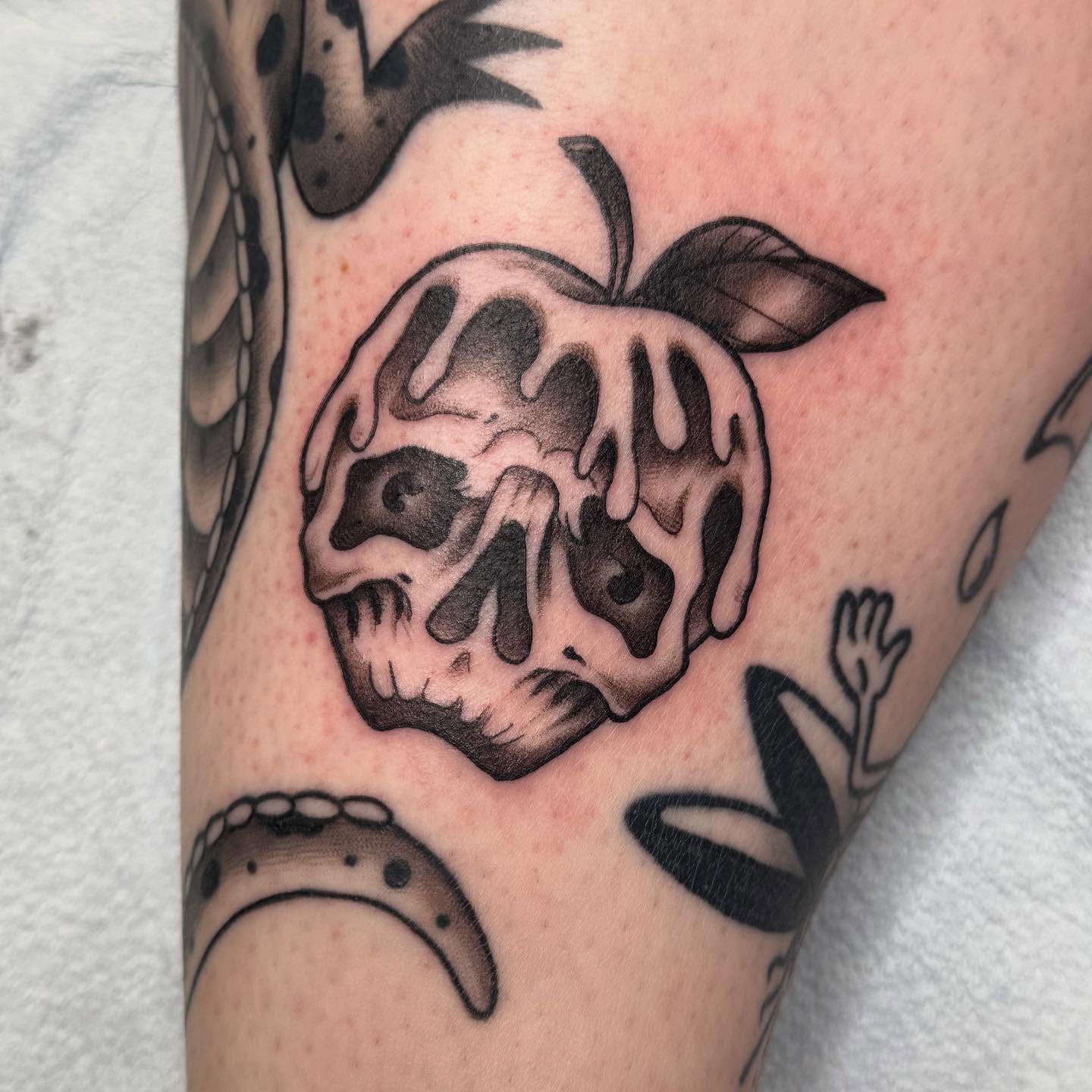Melting skull dark realism tattoo on the forearm by Nikki Powills