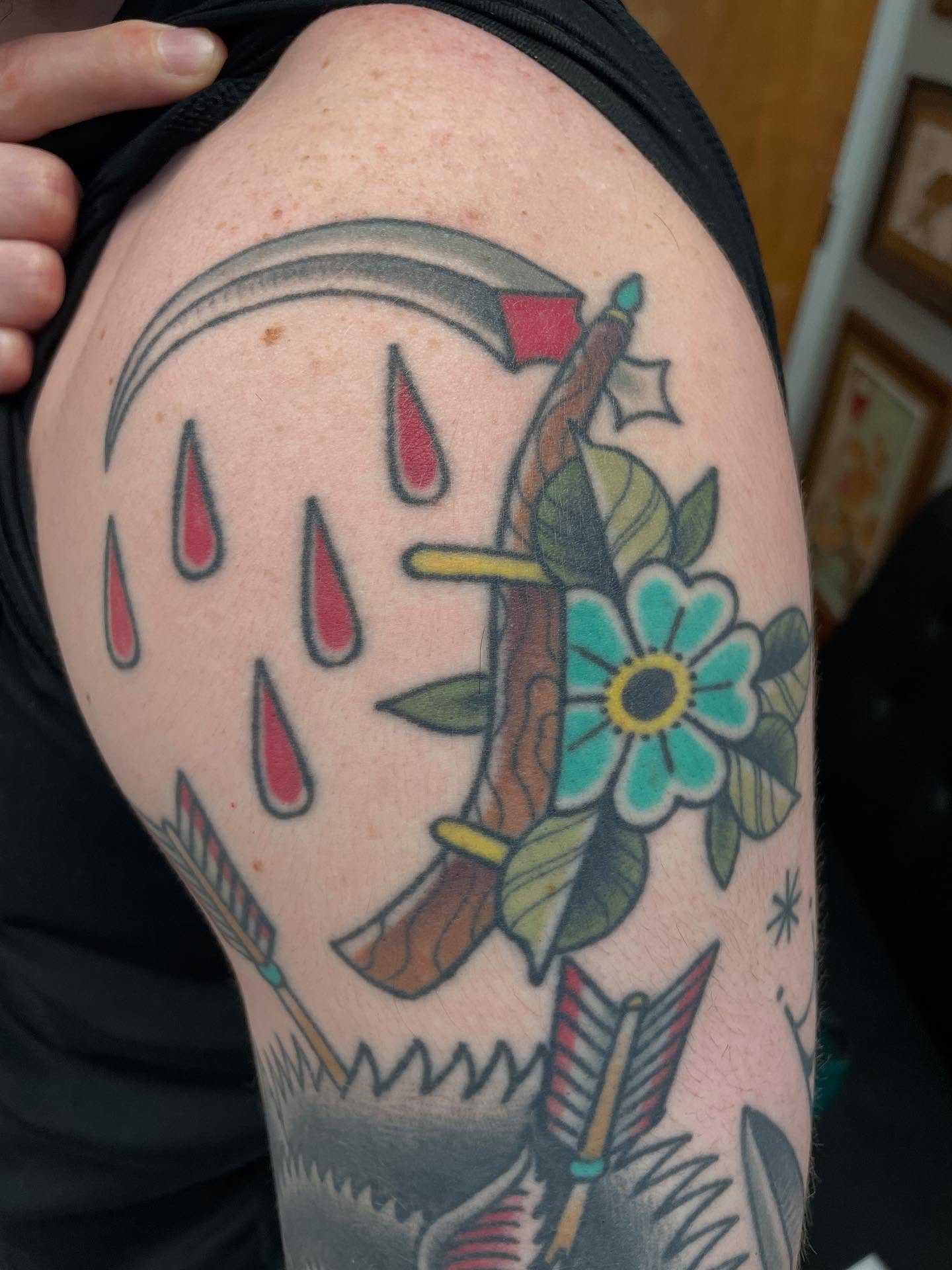 Scythe and flower American traditional tattoo on the shoulder by Josh Johns