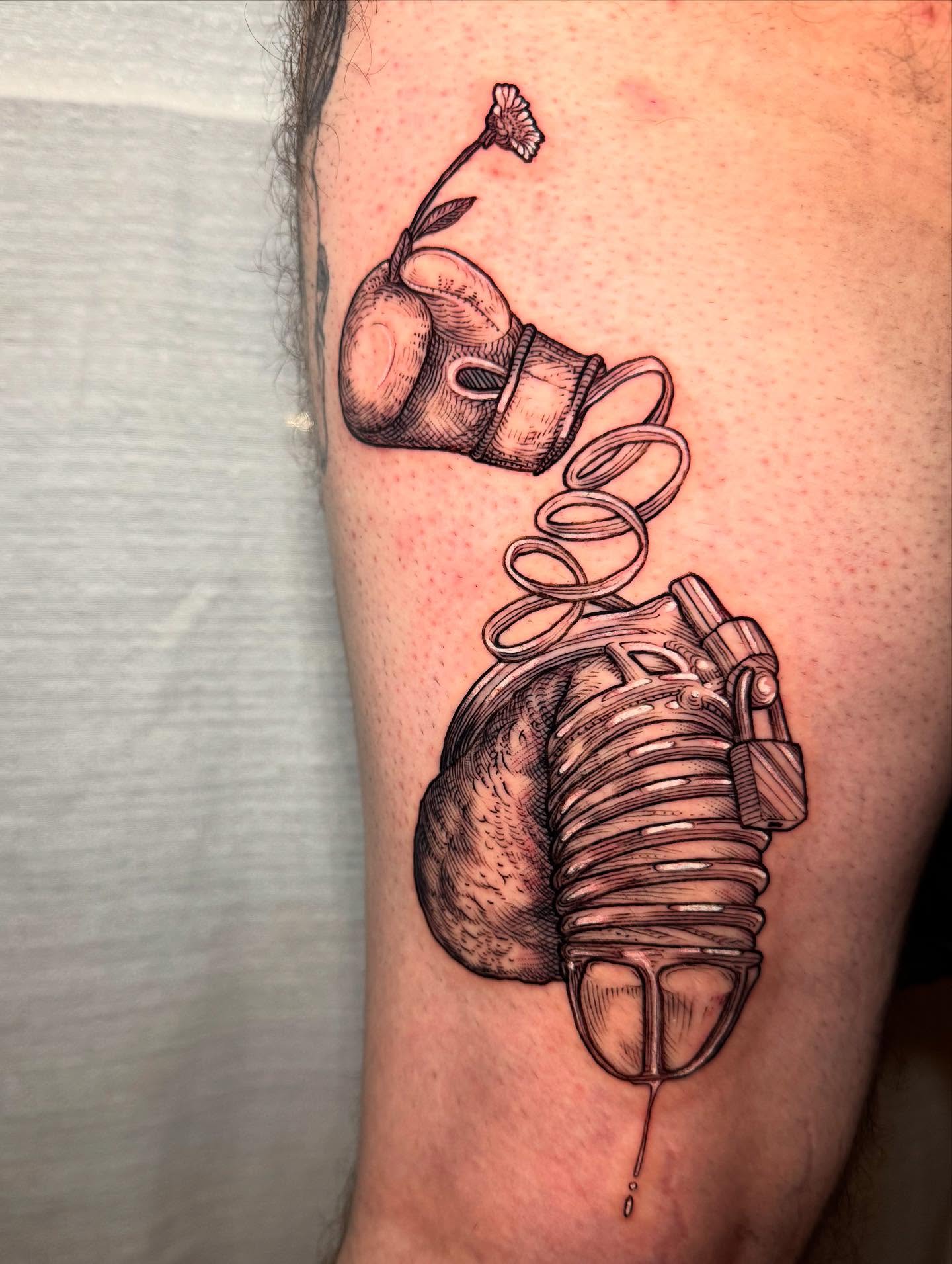 Heart and gas mask realism tattoo on the forearm by Landon Morgan