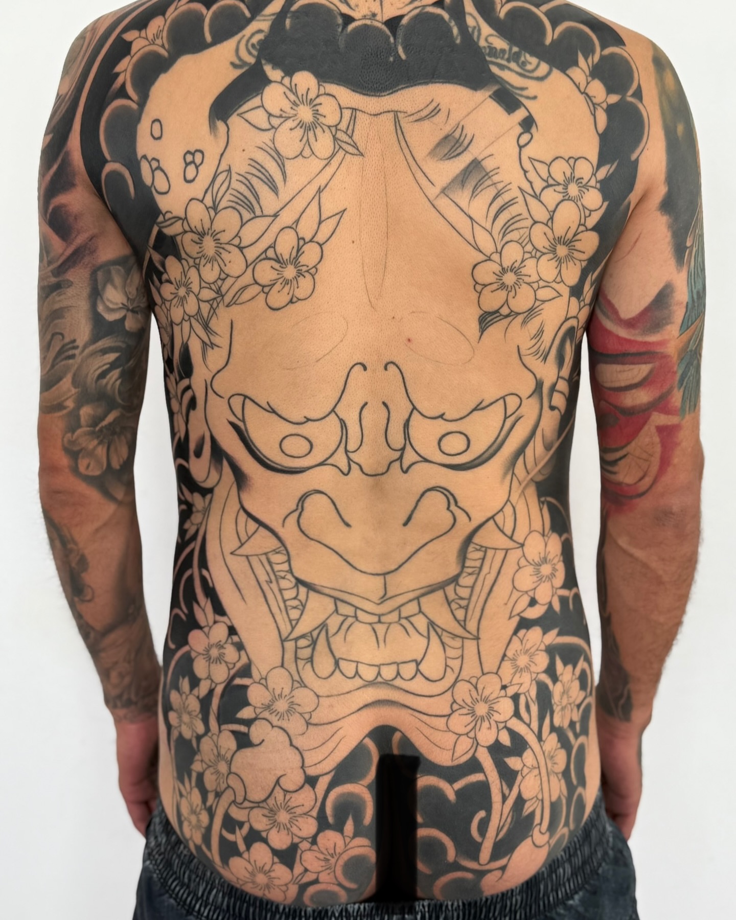 Mask japanese irezumi tattoo on the back by Meza Cruz