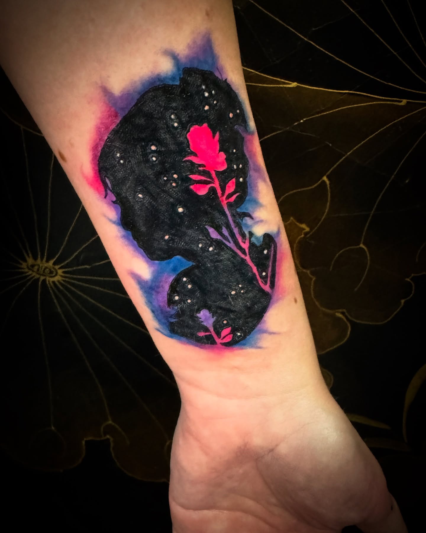 Night sky with rose dotwork tattoo on the forearm by Christa Martinez