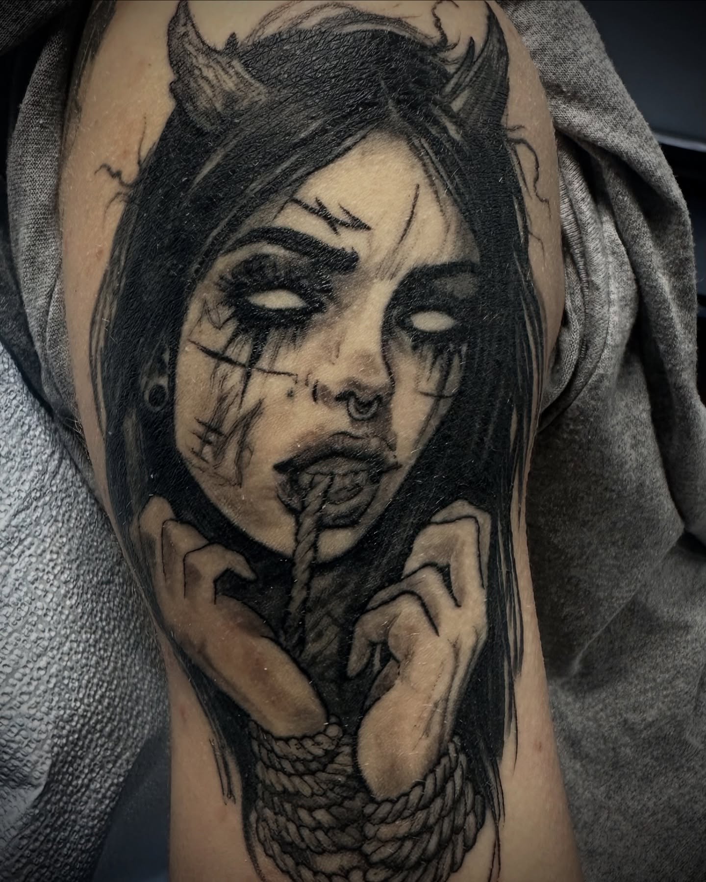 Woman with rope dark realism tattoo on the forearm by Culleton Paramore
