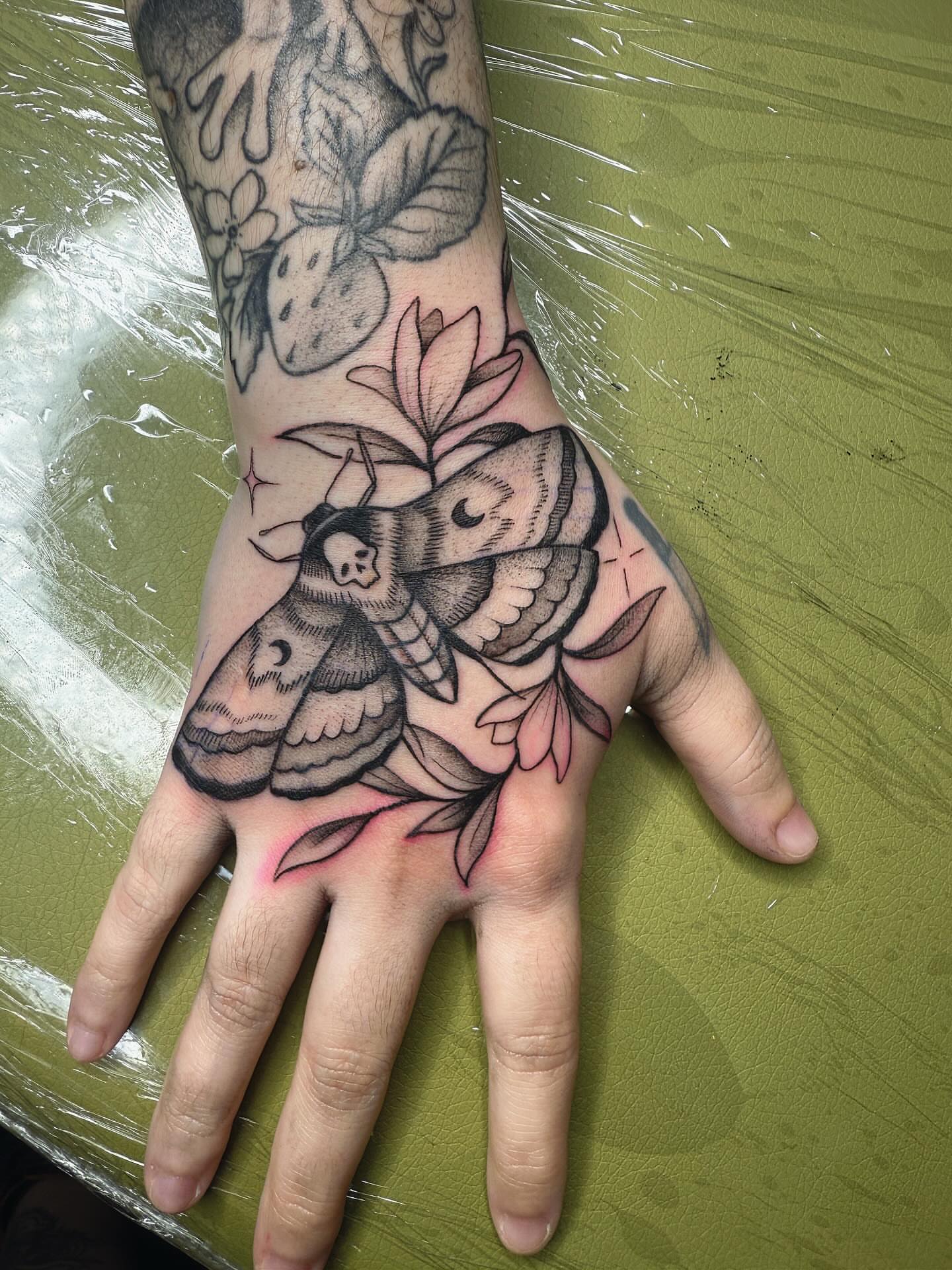 Moth and floral American traditional tattoo on the hand by π½πππππ π½πππππππ, New Orleans, Louisiana