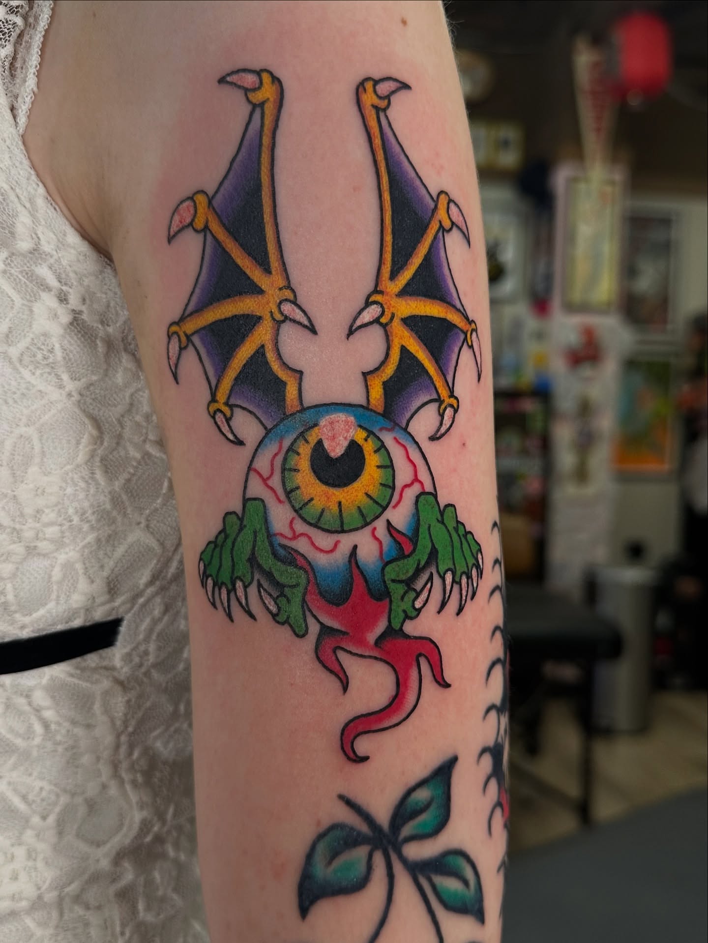 Eye with tentacles surrealism tattoo on the forearm by Emily Masa