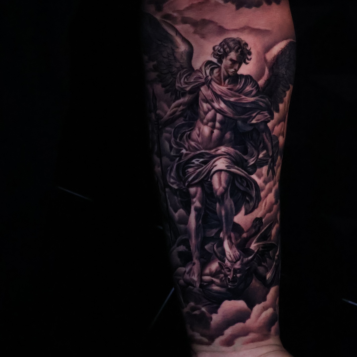 Angel battling demon realism tattoo on the forearm by Angels tattoo