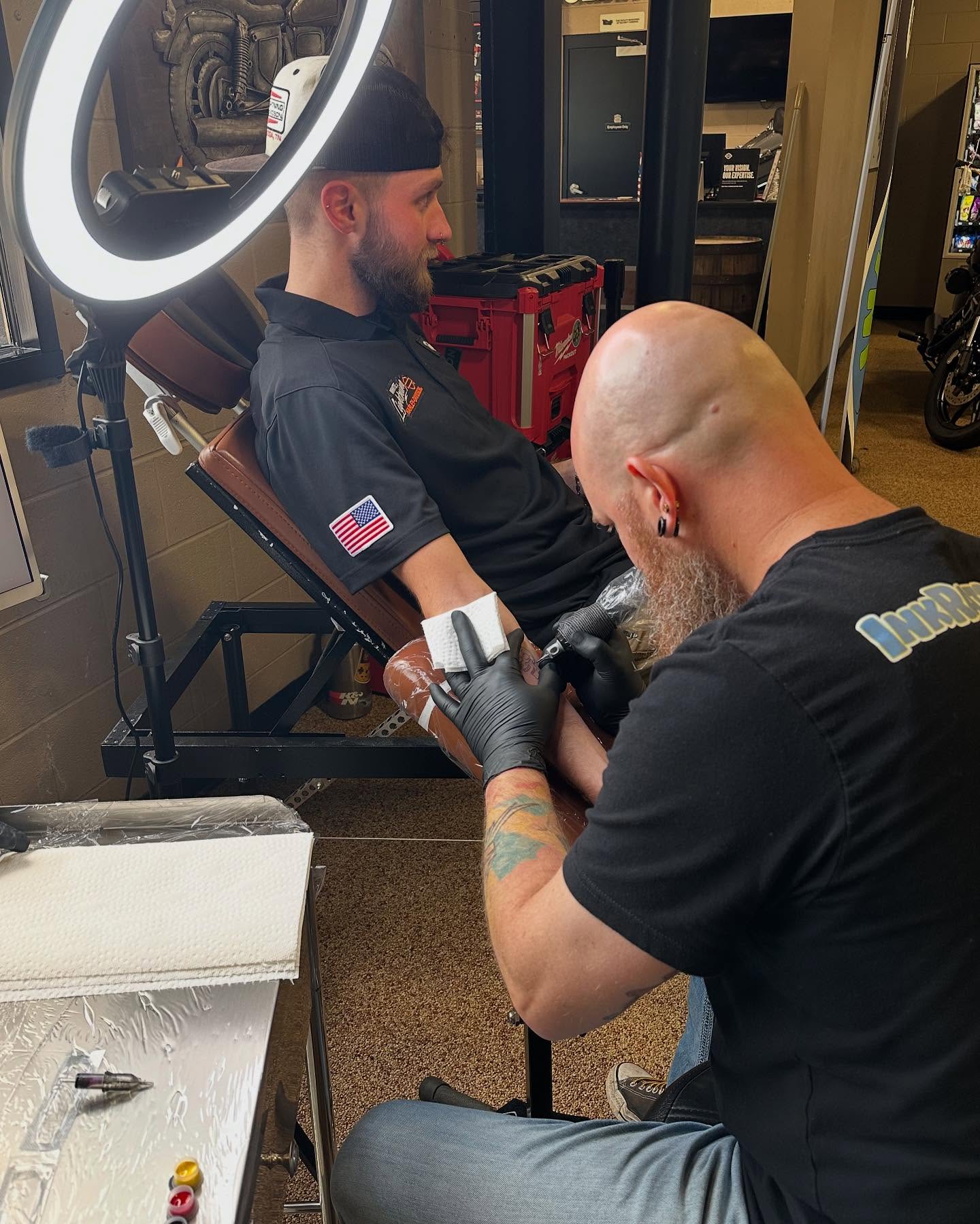 Bearded man American traditional tattoo on the upper arm by Chadrick Gregory