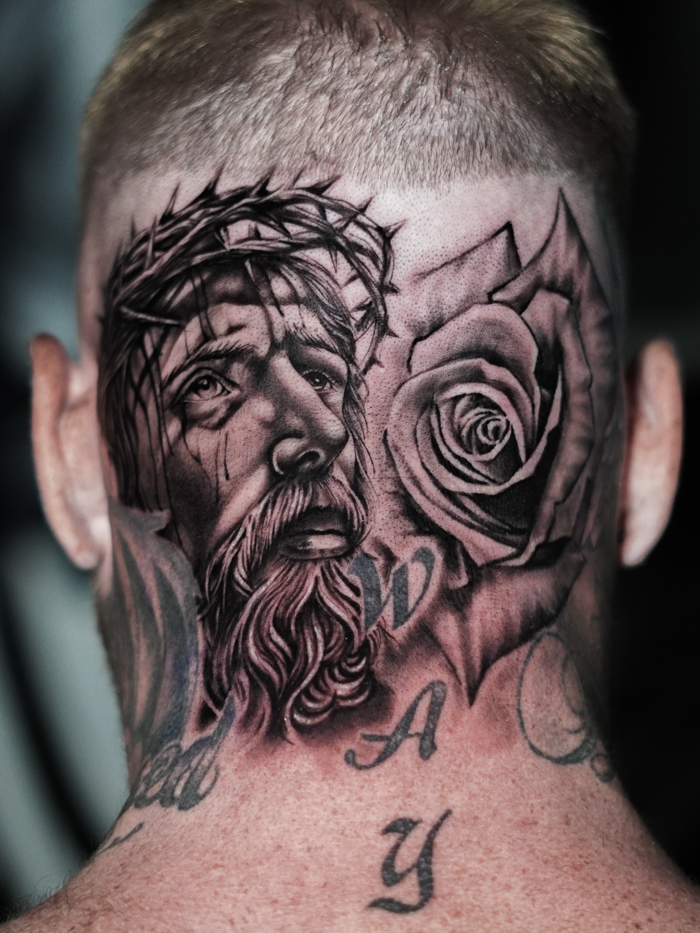 Jesus Christ and rose realism tattoo on the neck by Angel Gonzalez