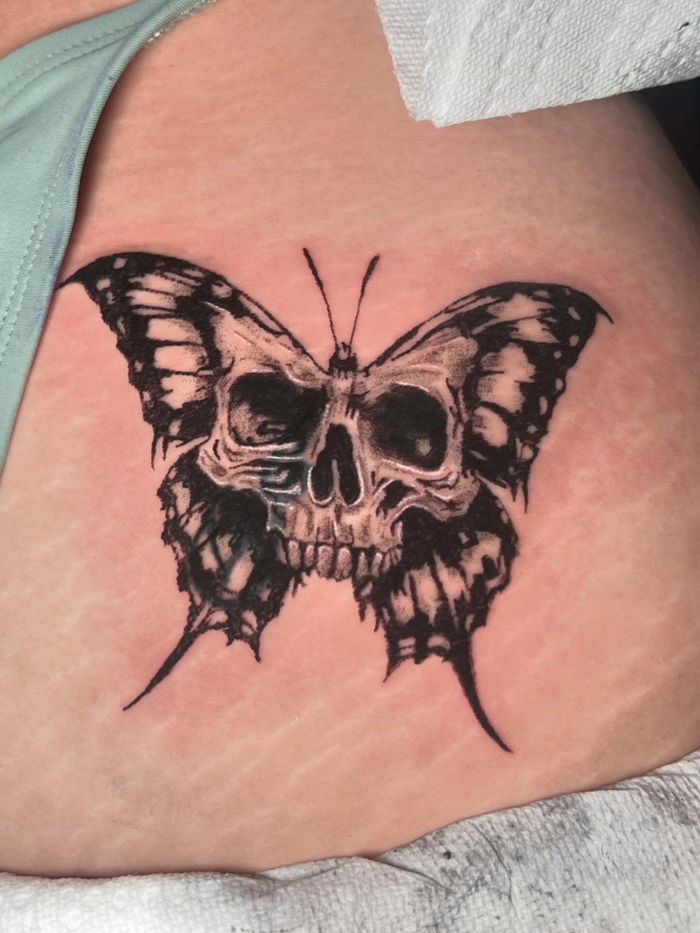 Skull and butterfly realism tattoo on the thigh by Anthony “Jiinky” Quintanilla 🧸☁️