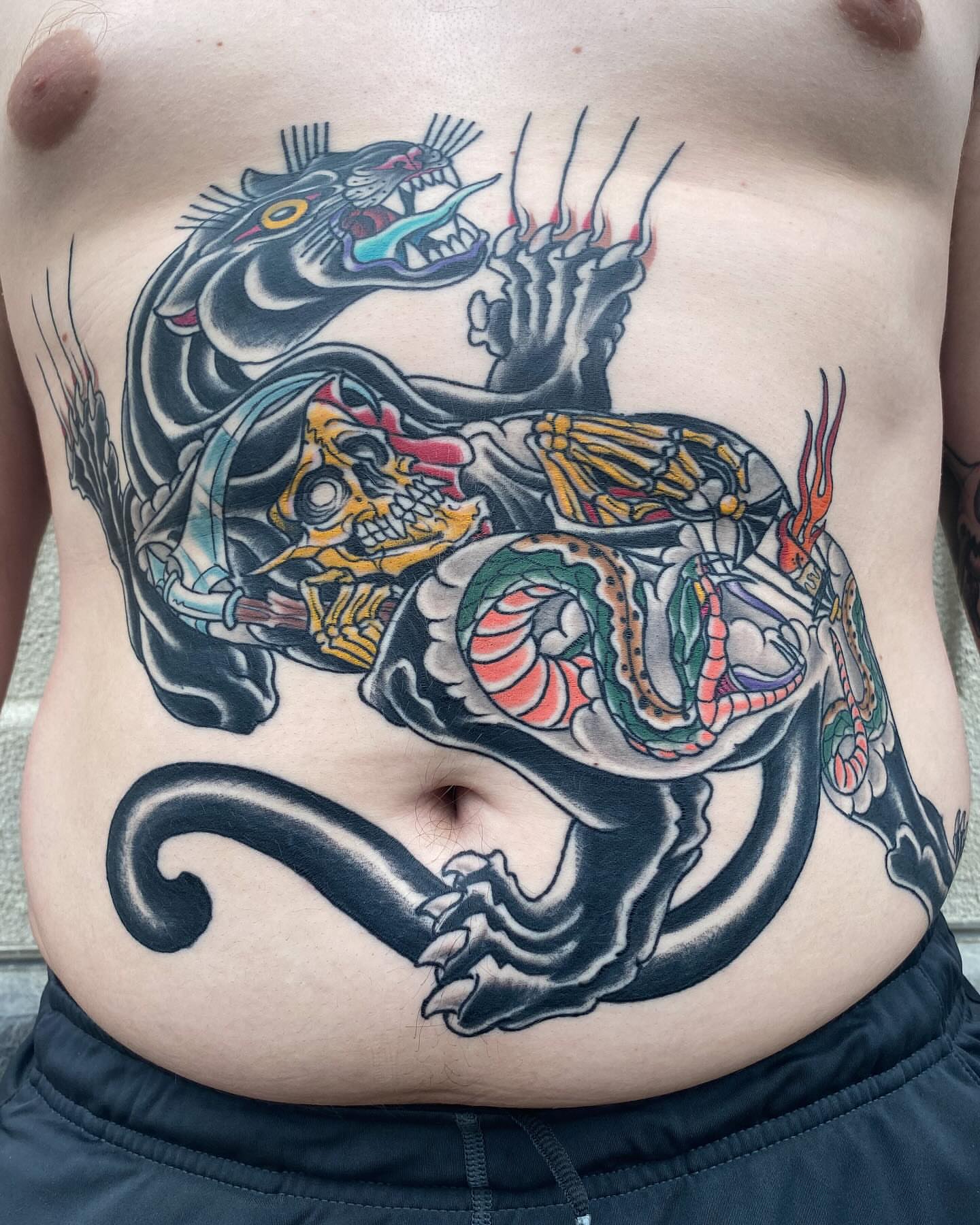 Panther and skull American traditional tattoo on the torso by Bob Lackner