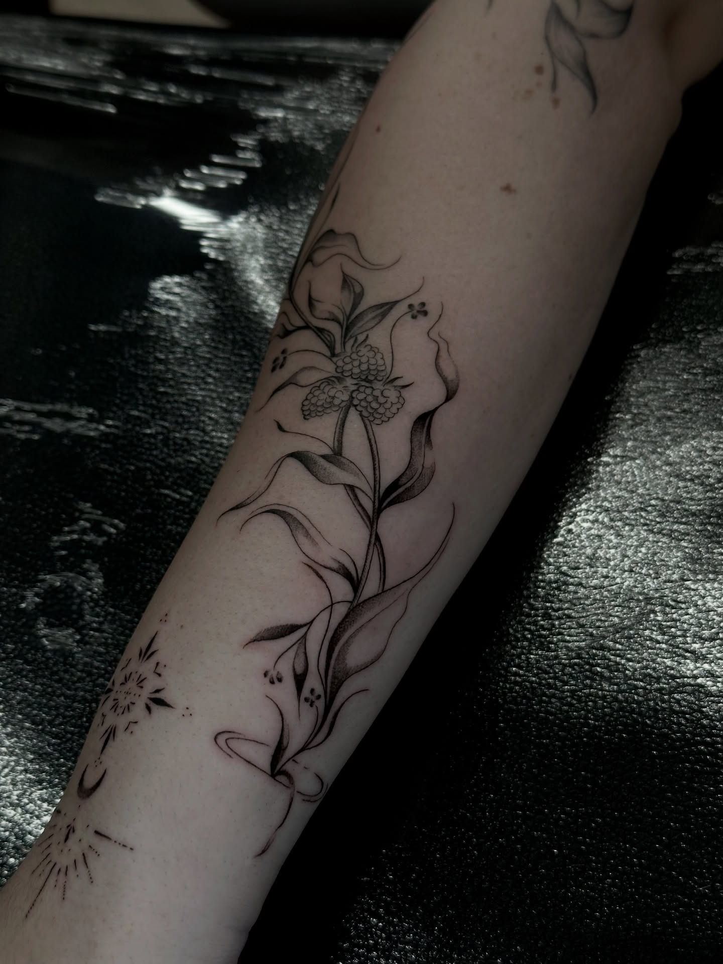 Flower and leaves black and grey tattoo on the forearm by πΈππππ