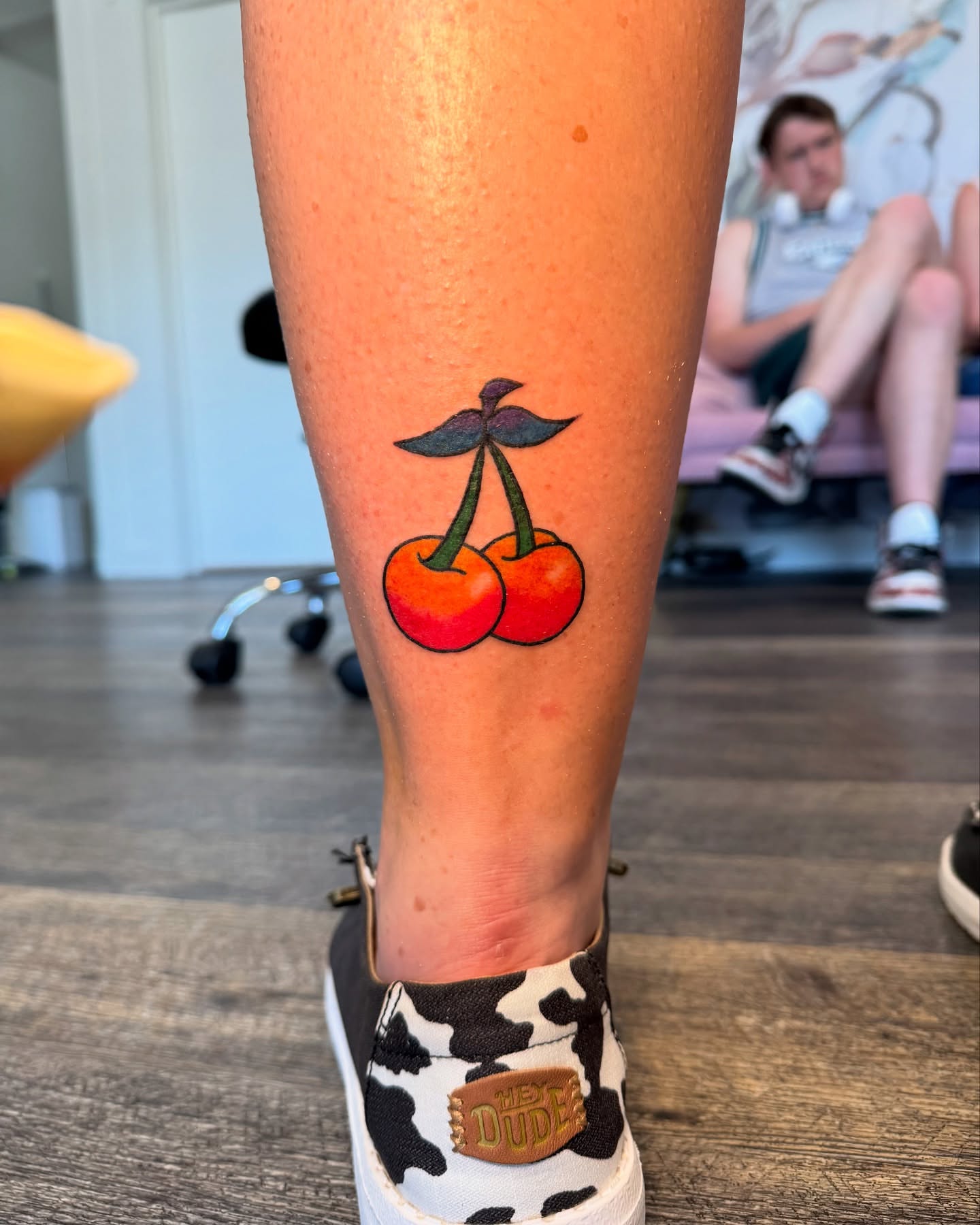 Cherries realism tattoo on the calf by Kinzi Brown