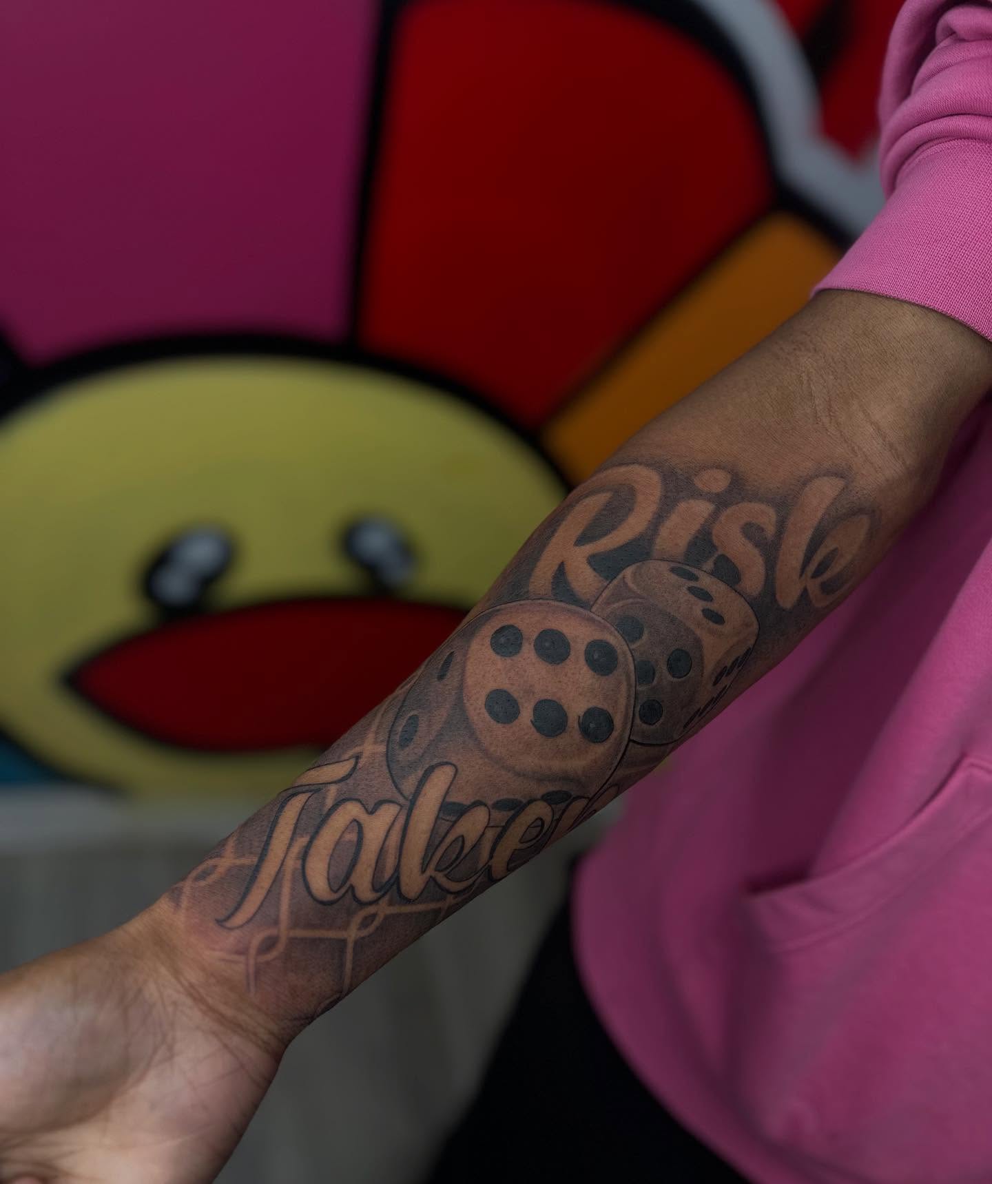 Dice and text dotwork tattoo on the forearm by Antonio