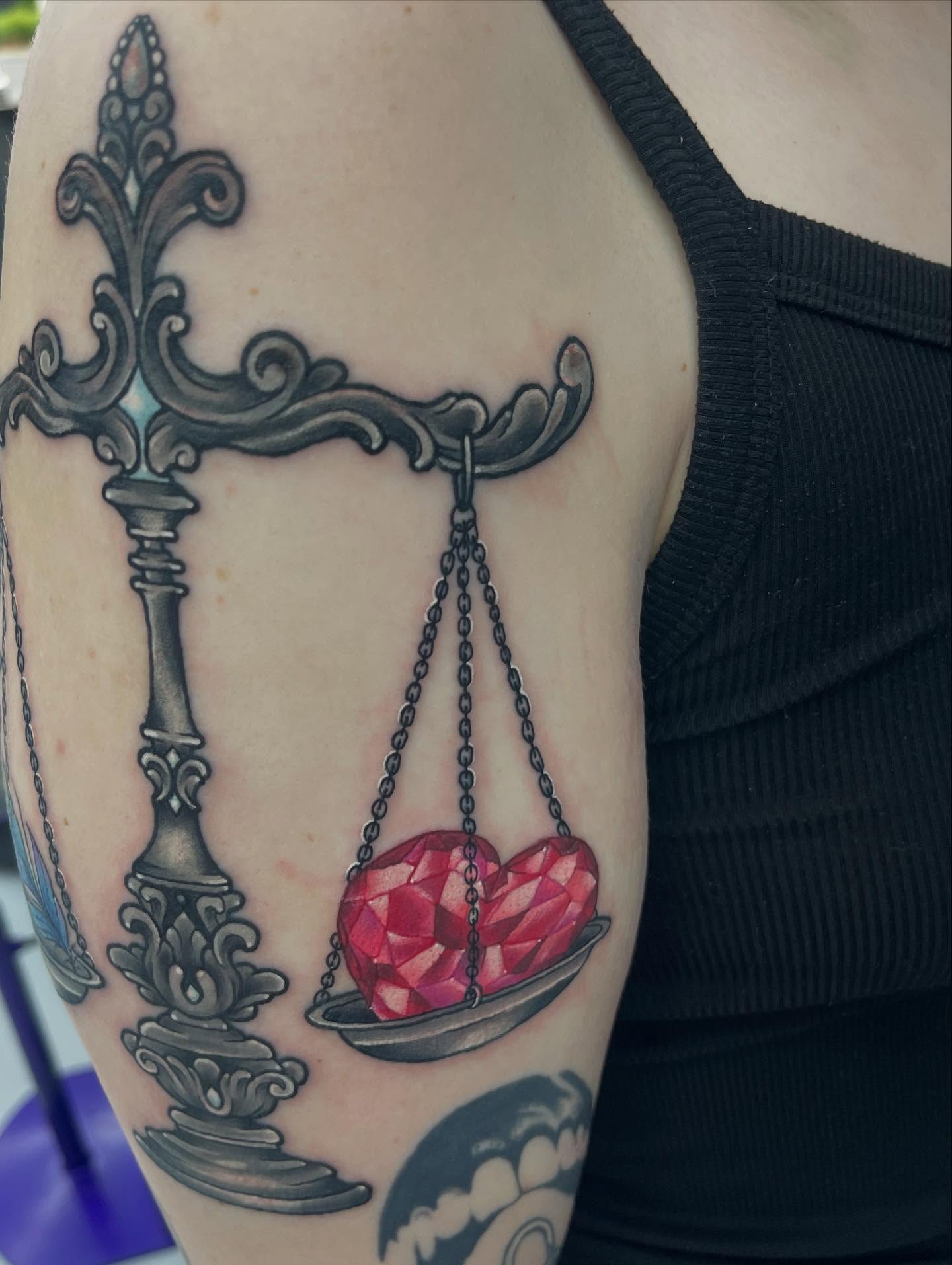 Scale with heart realism tattoo on the forearm by Autumn Fulford