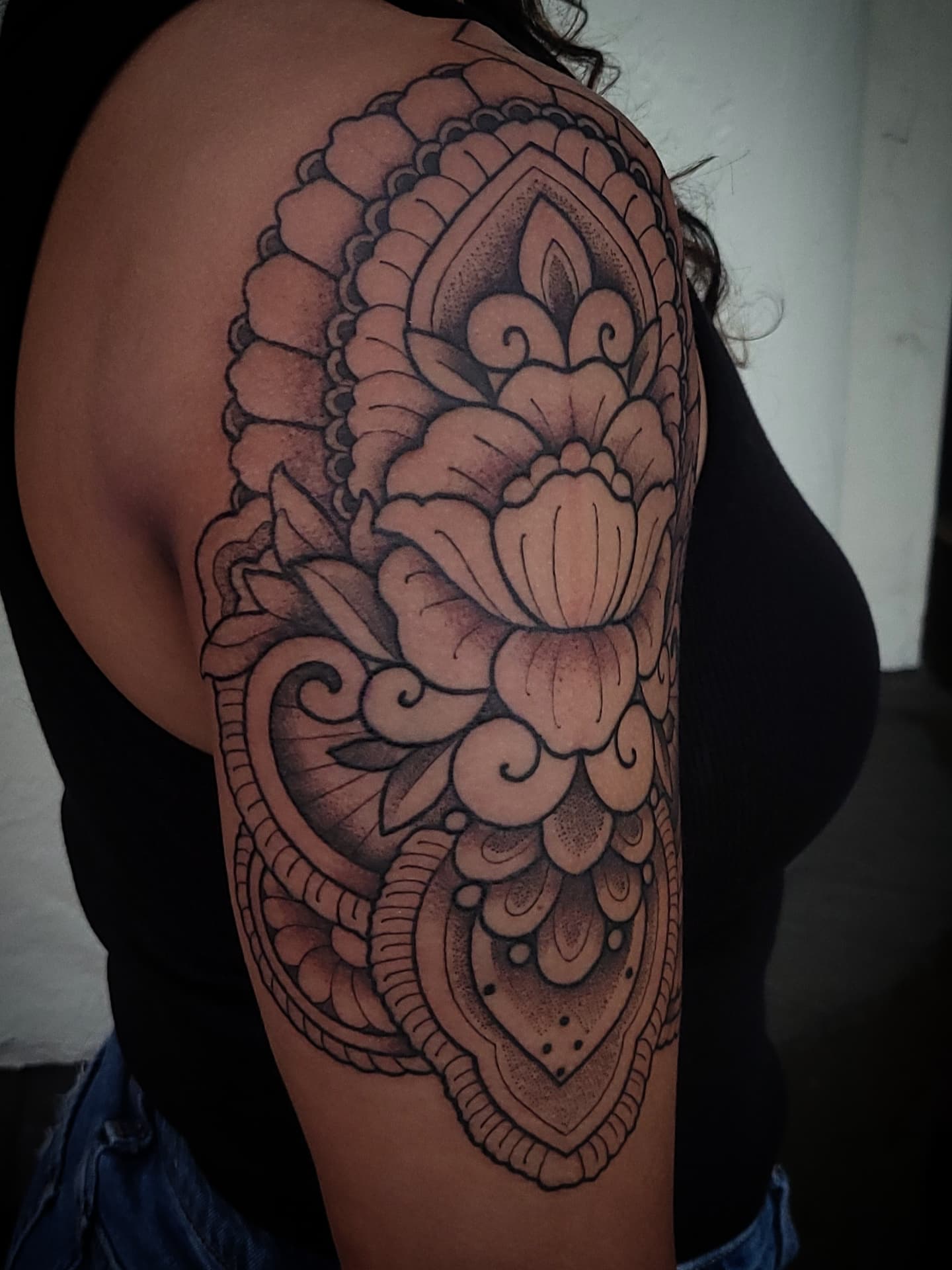 Floral mandala dotwork tattoo on the shoulder by Sean Hollinger