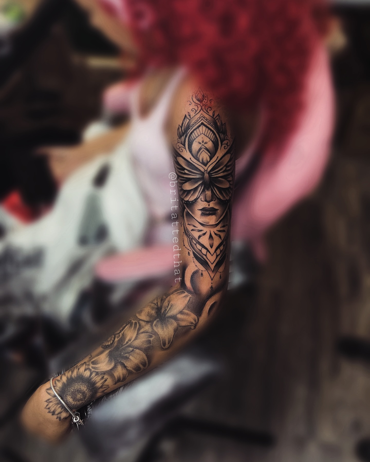 Mask and floral geometric tattoo on the forearm by Bri Tatted That